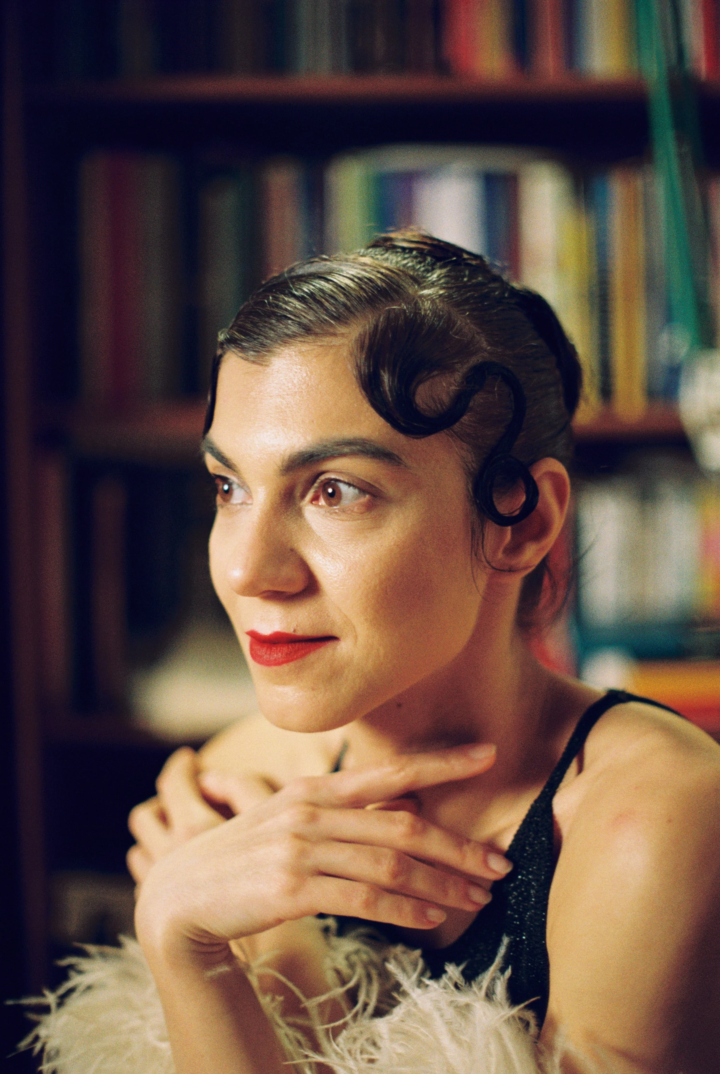 Close up color portrait of jazz singer Sorina Rotaru, vintage curl hairstyle, red lipstick, library background
