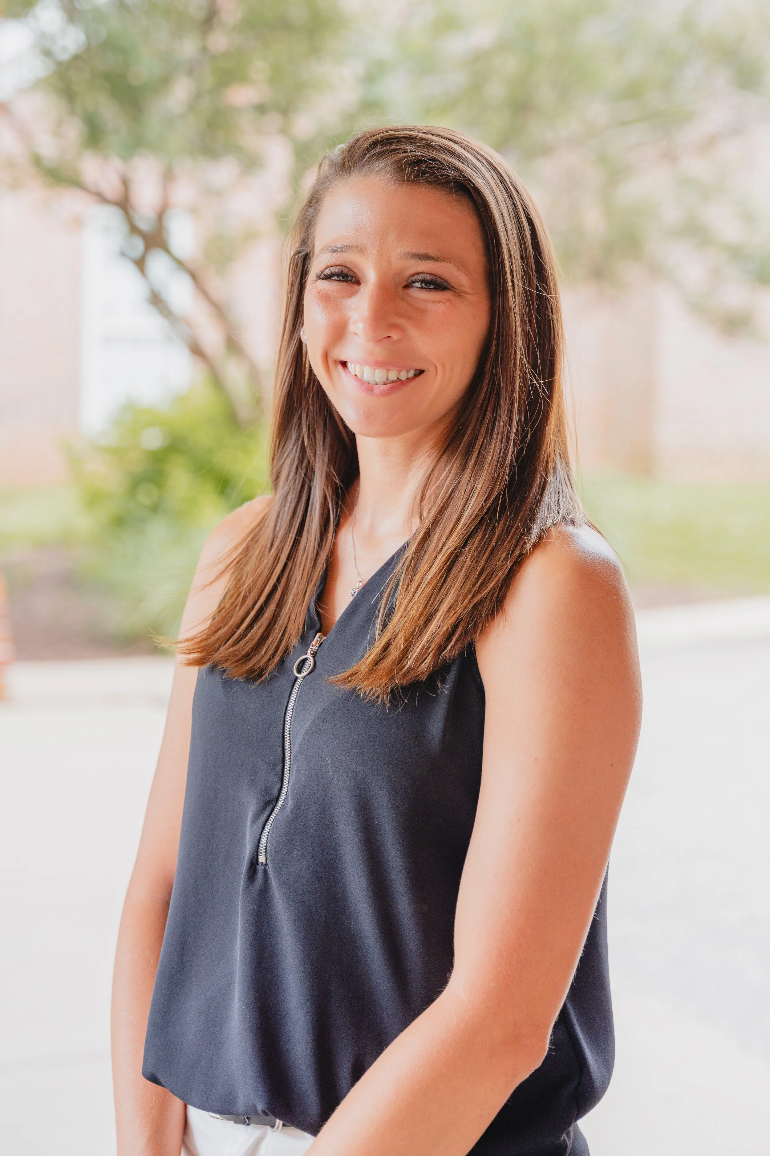 Outdoor headshot of Meagan Hardison, H&V practice manager wearing a black shirt