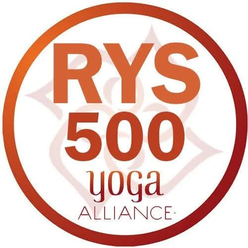 Logo for RYS 500 Yoga Alliance with an orange and red circular border, featuring the text "RYS 500 Yoga Alliance" and a stylized lotus flower in the background.