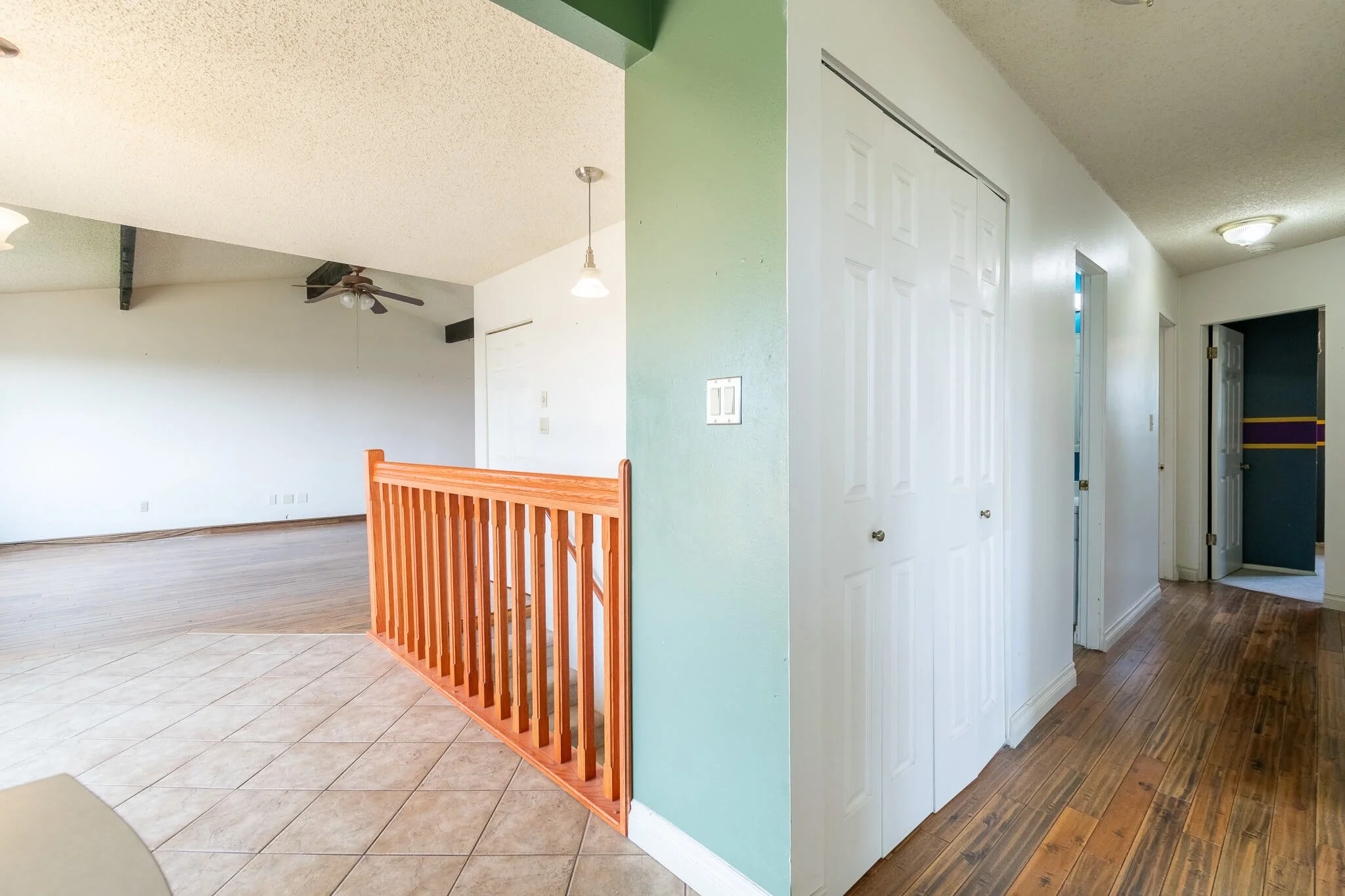 Original hallway before renovation with lowered entry and railing in a Great Falls, Montana home.