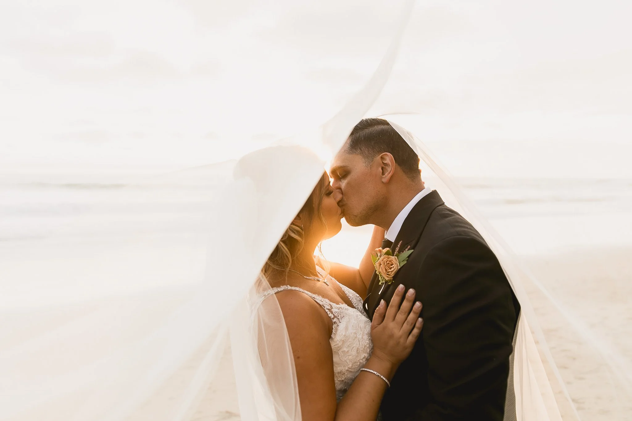 moody-beach-sunset-kiss-wedding-photo-silhouette-1.jpg