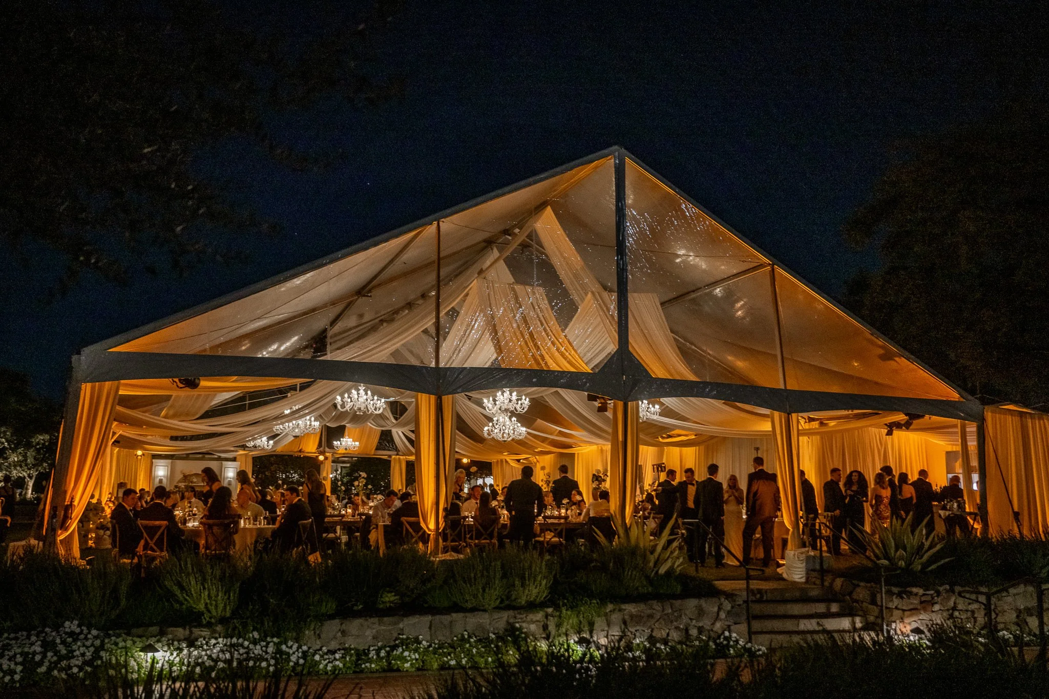 andlelit wedding reception with uplighting creating warm ambiance at Orange County venue