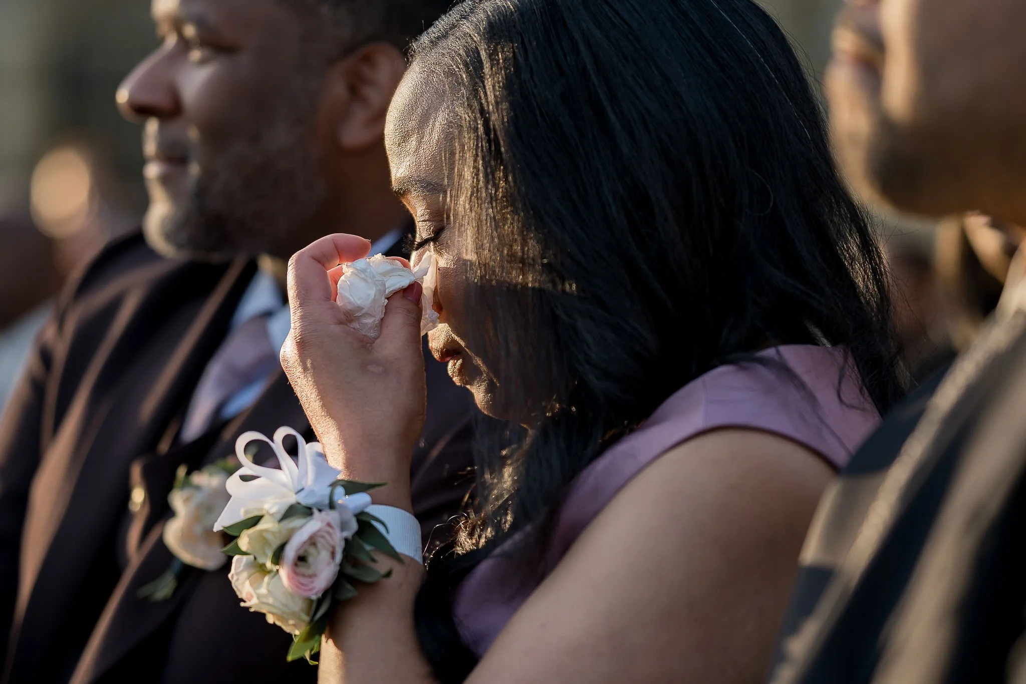 Emotional, candid documentary photo capturing the mother of the groom crying during the wedding ceremony.