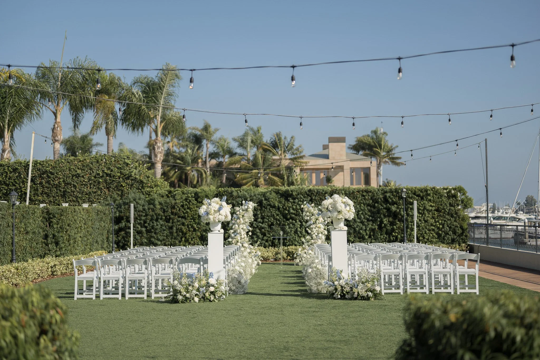 wedding ceremony at Balboa Bay Resort Bayfront Lawn captured by One Story Weddings