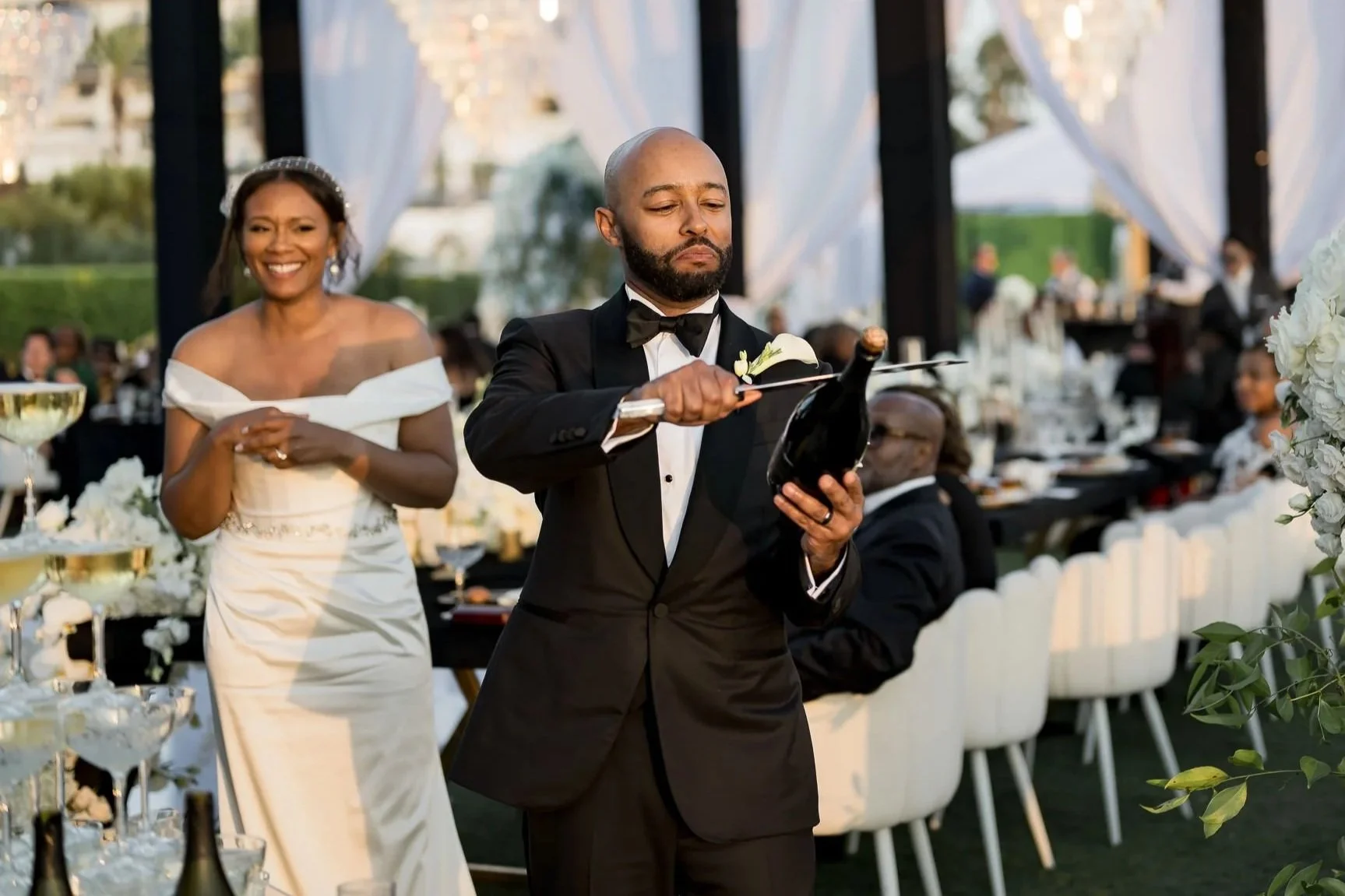 Champagne sabering at luxury wedding reception Monarch Beach Orange County