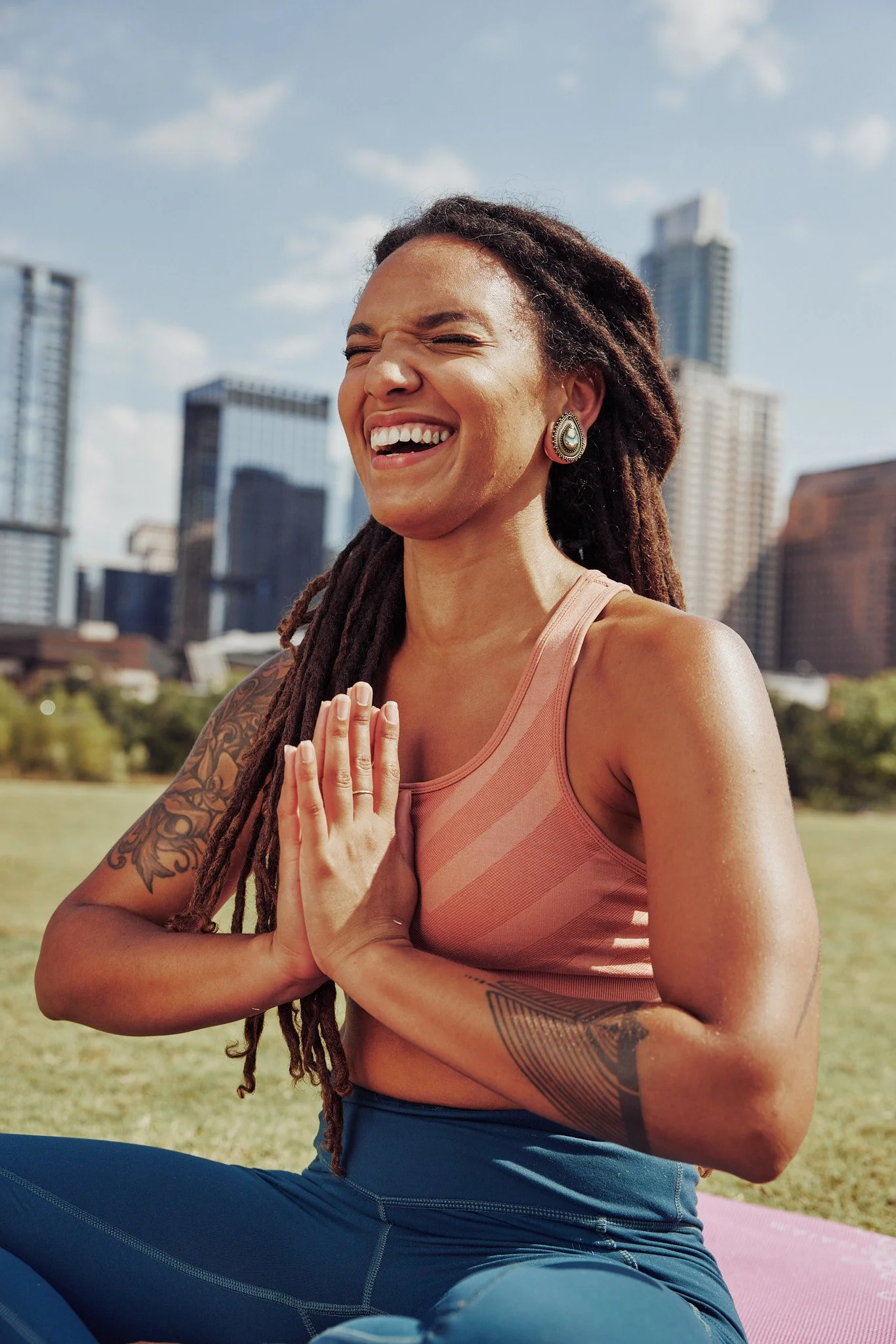 Woman laughing during outdoor yoga in Austin, Smartwool Spring 2021 campaign, photography by Dag Larson