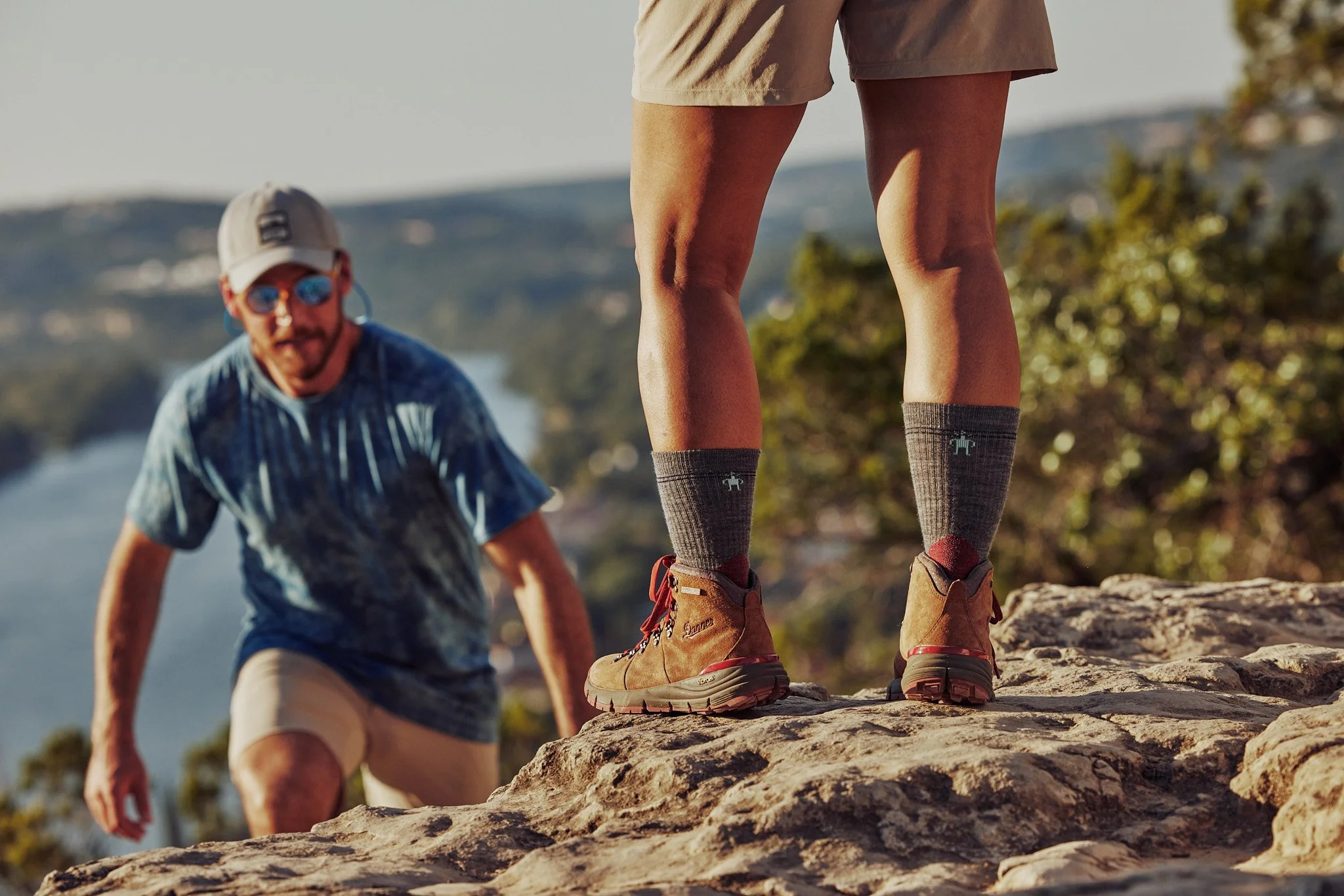 Couple scrambling up rocks on a Texas Hill Country hike, Smartwool Spring 2021 campaign, photography by Dag Larson
