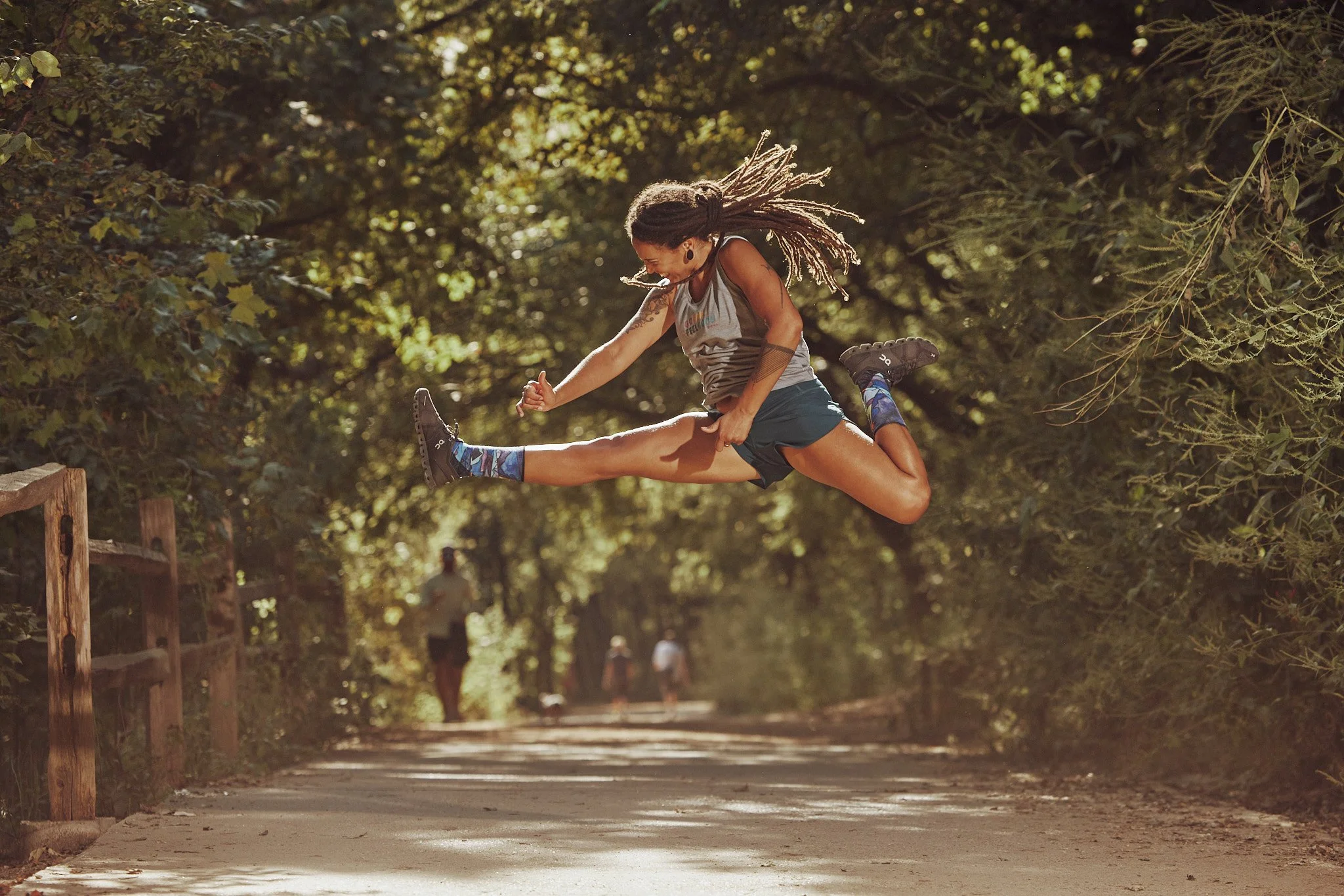 Trail runner leaping on a shaded Austin trail, Smartwool Spring 2021 campaign, photography by Dag Larson