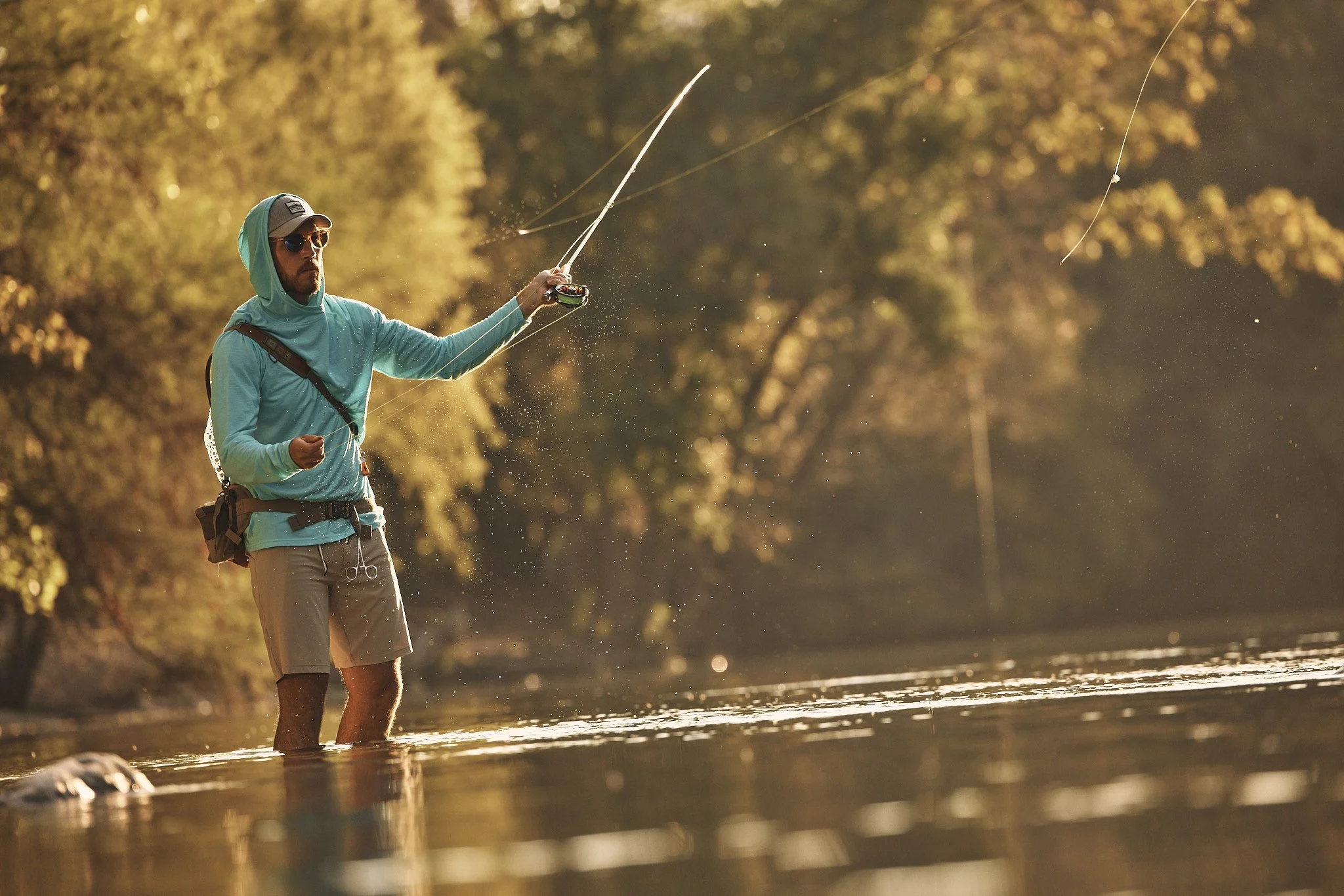 Angler casting a fly rod in a sunlit Texas river, Smartwool Spring 2021 campaign, photography by Dag Larson