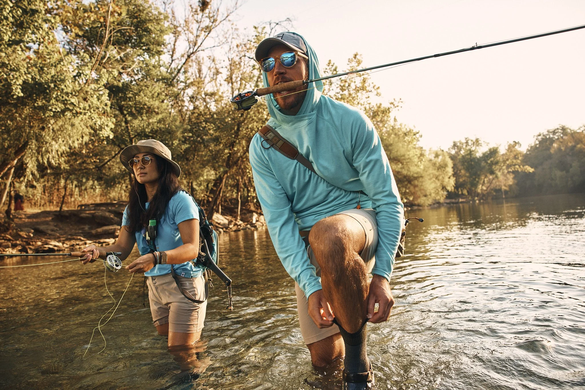 Couple fly fishing a river near Austin in Smartwool sun shirts, Smartwool Spring 2021 campaign, photography by Dag Larson