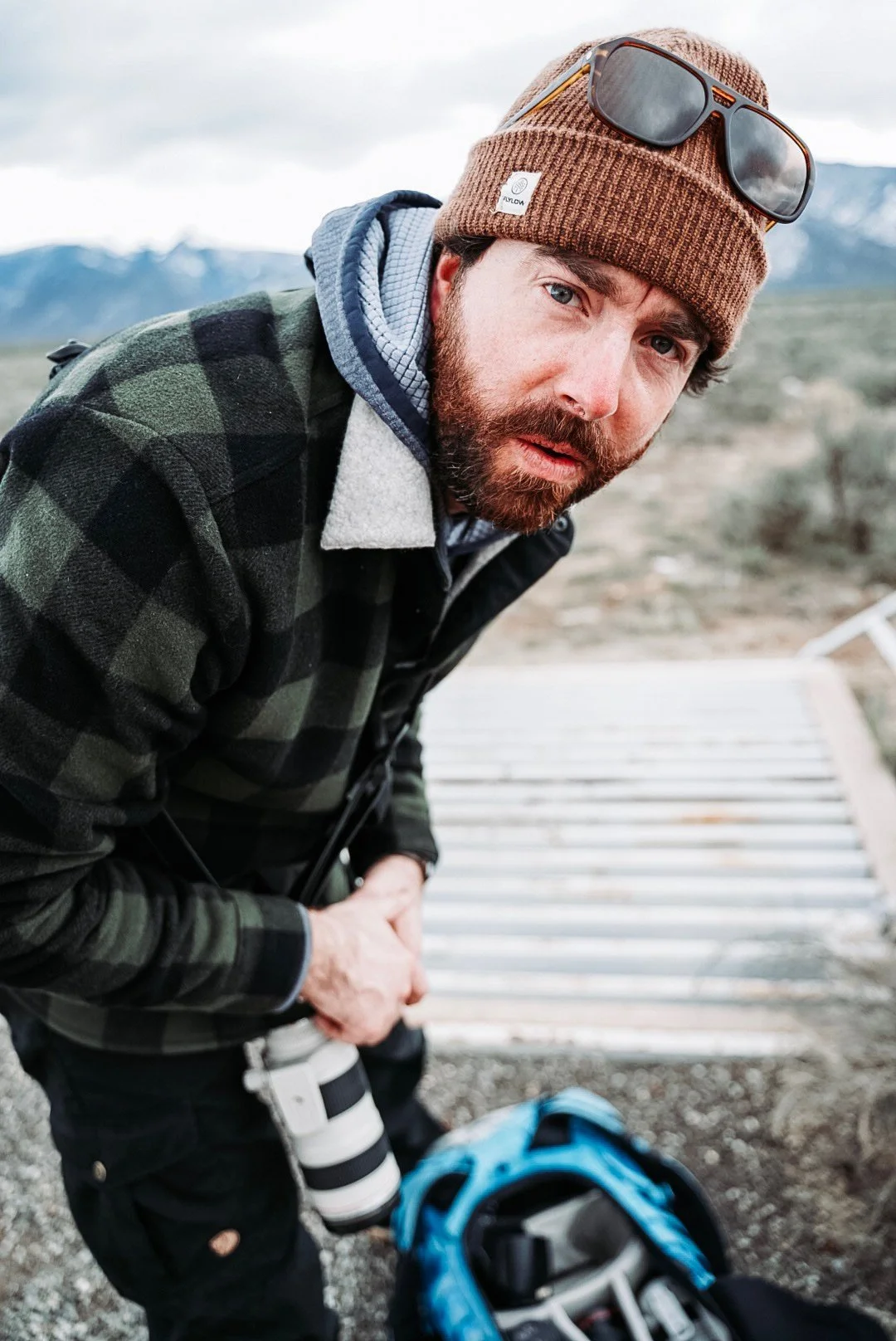 Dag Larson on set with a telephoto lens and camera bag