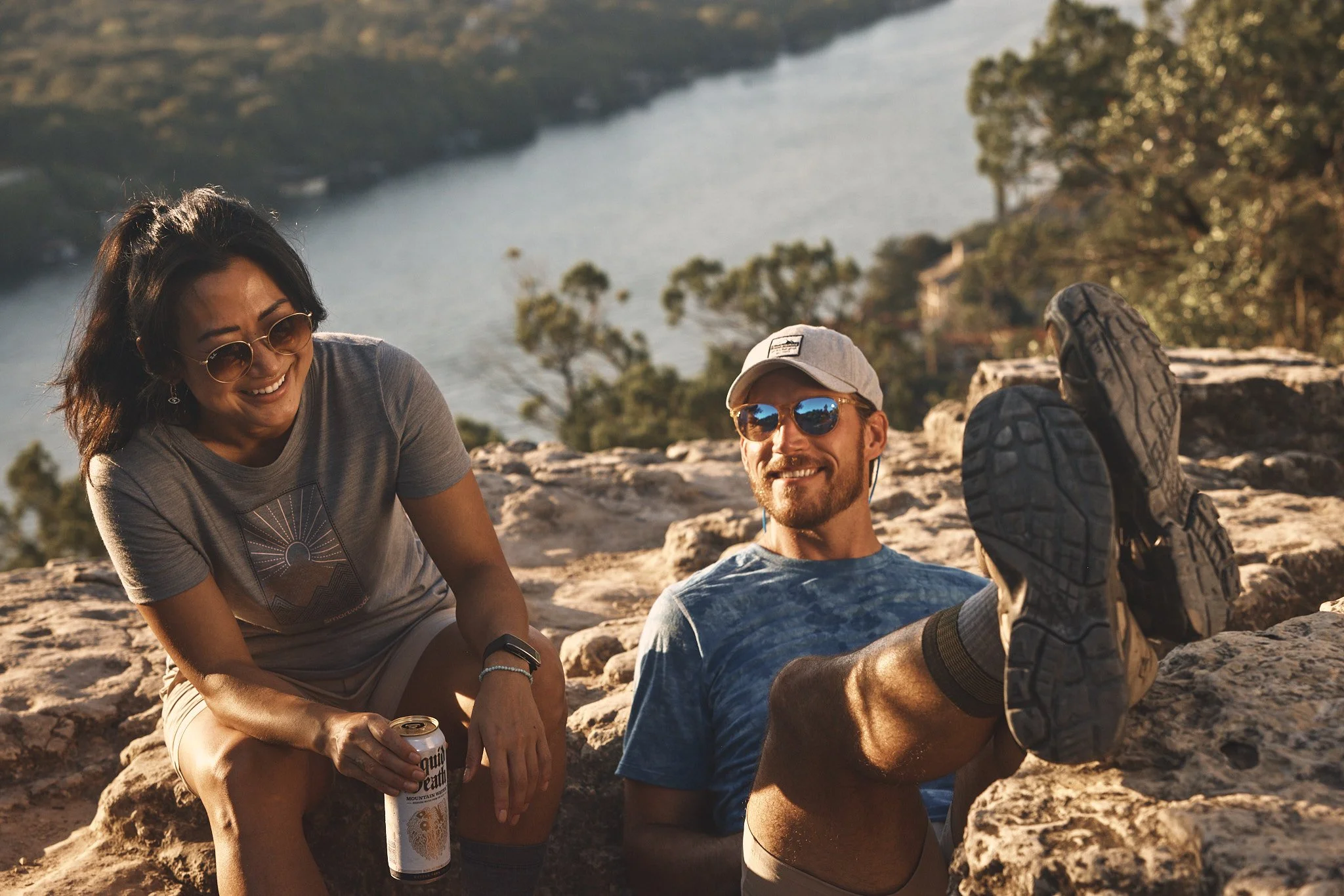 Couple resting on rocks above the water in Austin, Smartwool Spring 2021 campaign, photography by Dag Larson