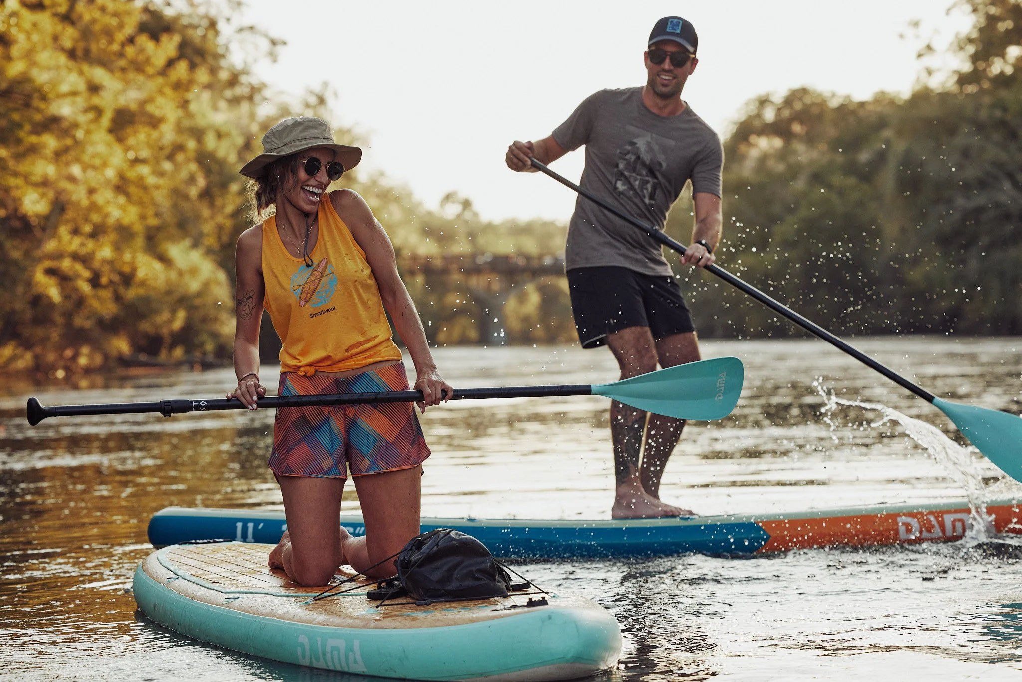 Friends paddleboarding and wading in an Austin river, Smartwool Spring 2021 campaign, photography by Dag Larson