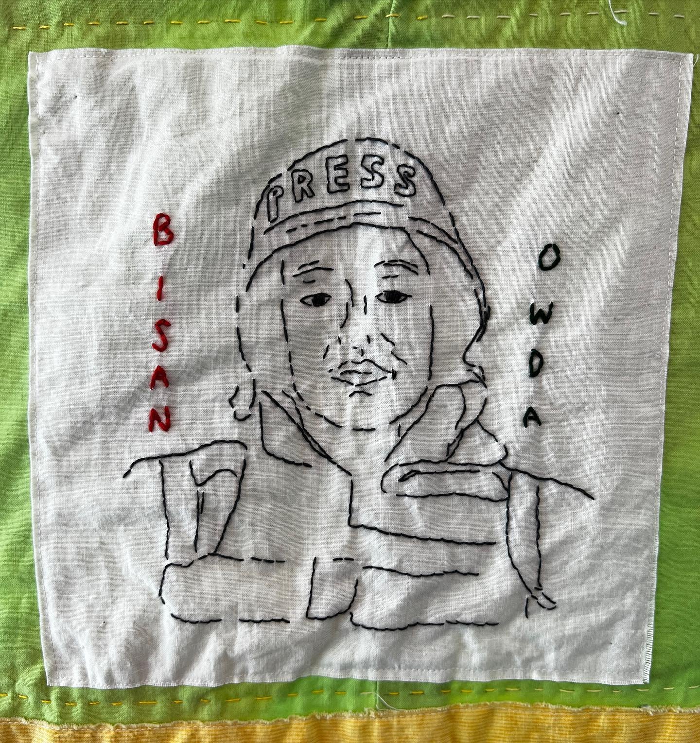 An embroidered portrait of @wizard_bisan1 I made for the Strong Women quilt #FreePalestine 🇵🇸🍉

#CraftingChange #CommunityArtTherapy #ArtTherapy #Quilts #Craft #CraftActivism #Craftivism 

ID: a photo of a quilt, focused on a white square with an 