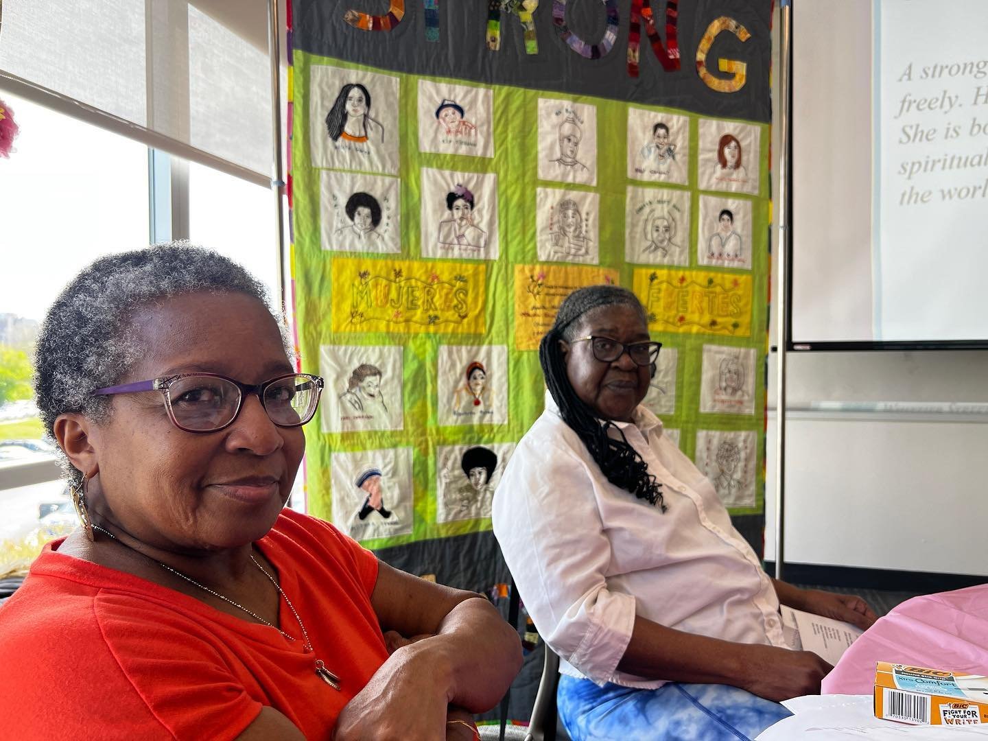 Leslie and Donna in front of the quilt, looking satisfied with our work 💖💖💖

#CraftingChange #CommunityArtTherapy #ArtTherapy #Quilts #Craft #CraftActivism #Craftivism

ID: a photo of two dark-skinned women, in front of a quilt. They&rsquo;re look