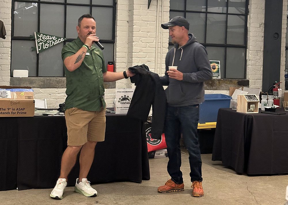 Our Executive Director, Aric W Manning, honoring our Trail Crew Lead, Bryce DiPoma, for his unwavering dedication to fixing our trails this past season.