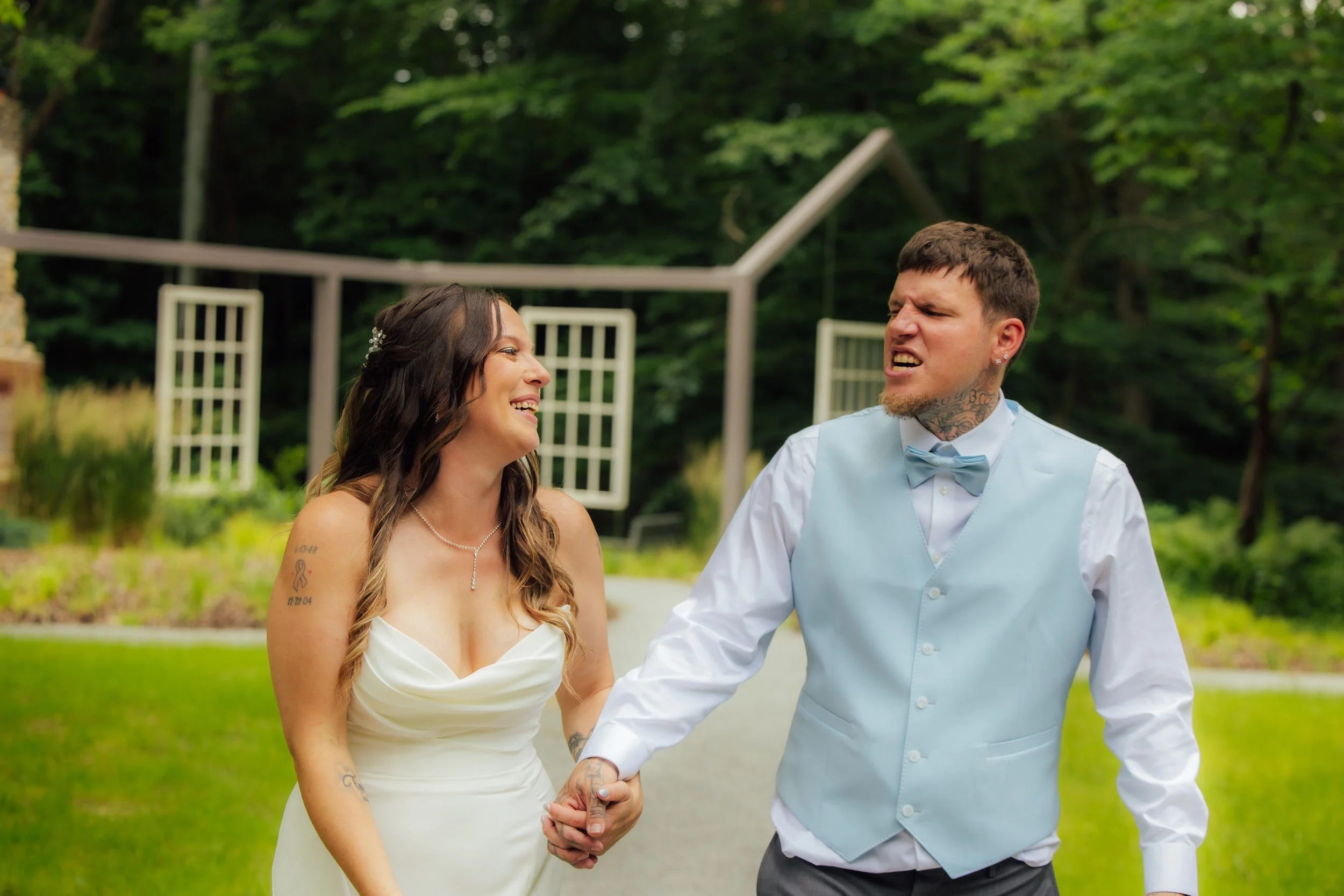 Newlyweds walking through Fernwood Botanical Garden