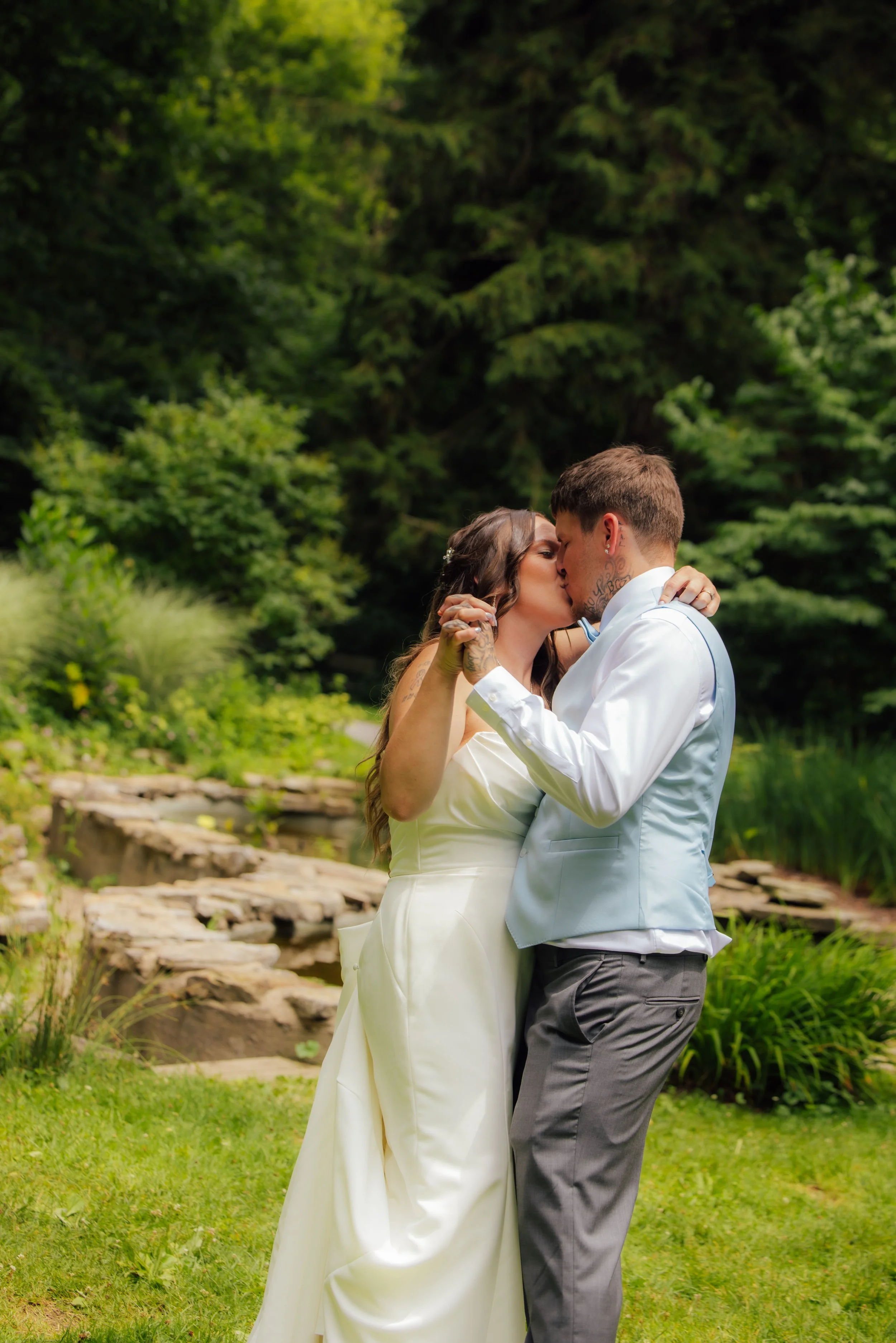 Intimate wedding portrait near the waterfall at Fernwood Botanical Garden