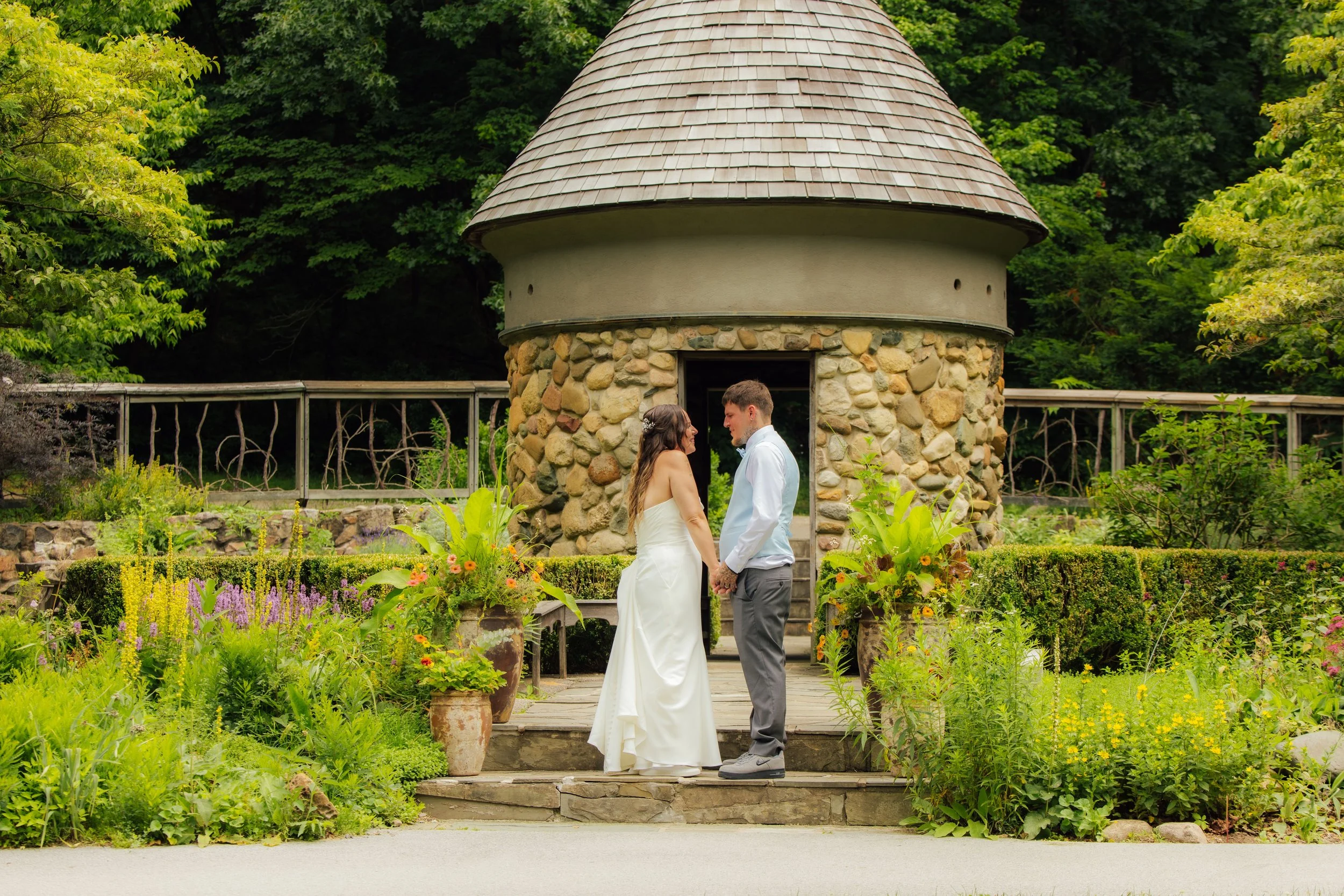 Tyler and Andrea embracing on their wedding day at Fernwood Botanical Garden in Niles, Michigan