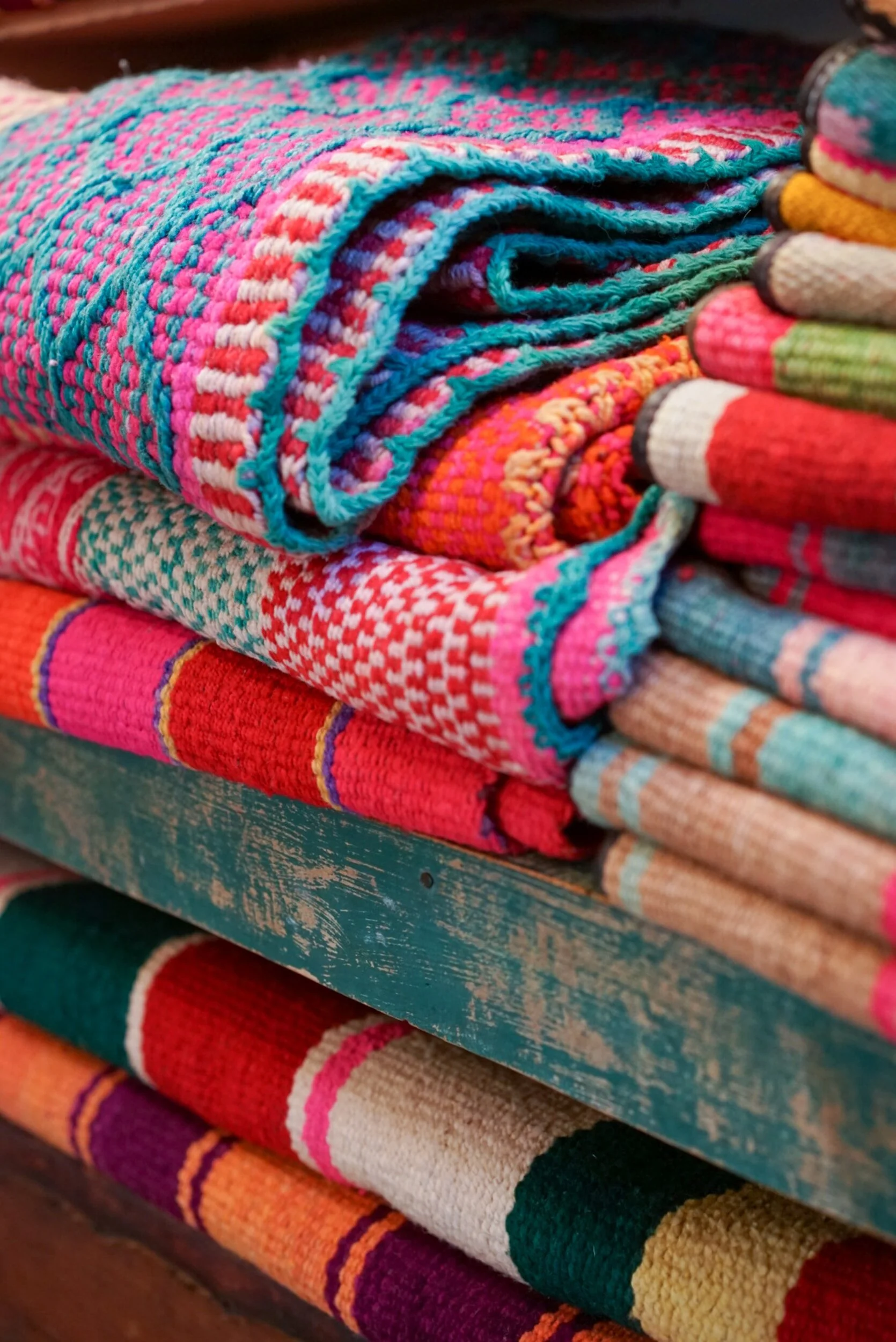 A stack of colorful blankets and throws