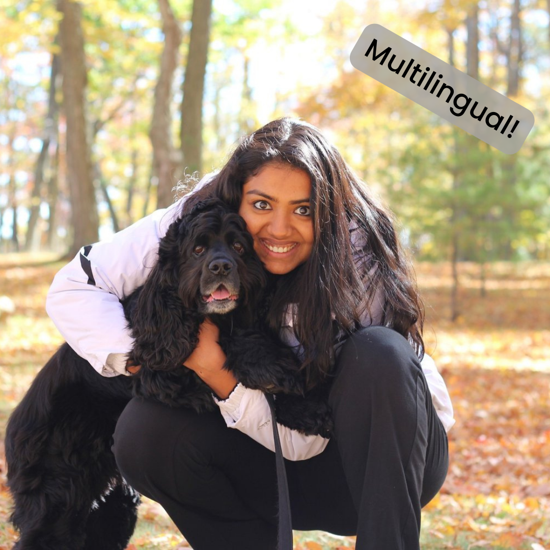 Natasha Mathew poses with a black Cocker Spaniel