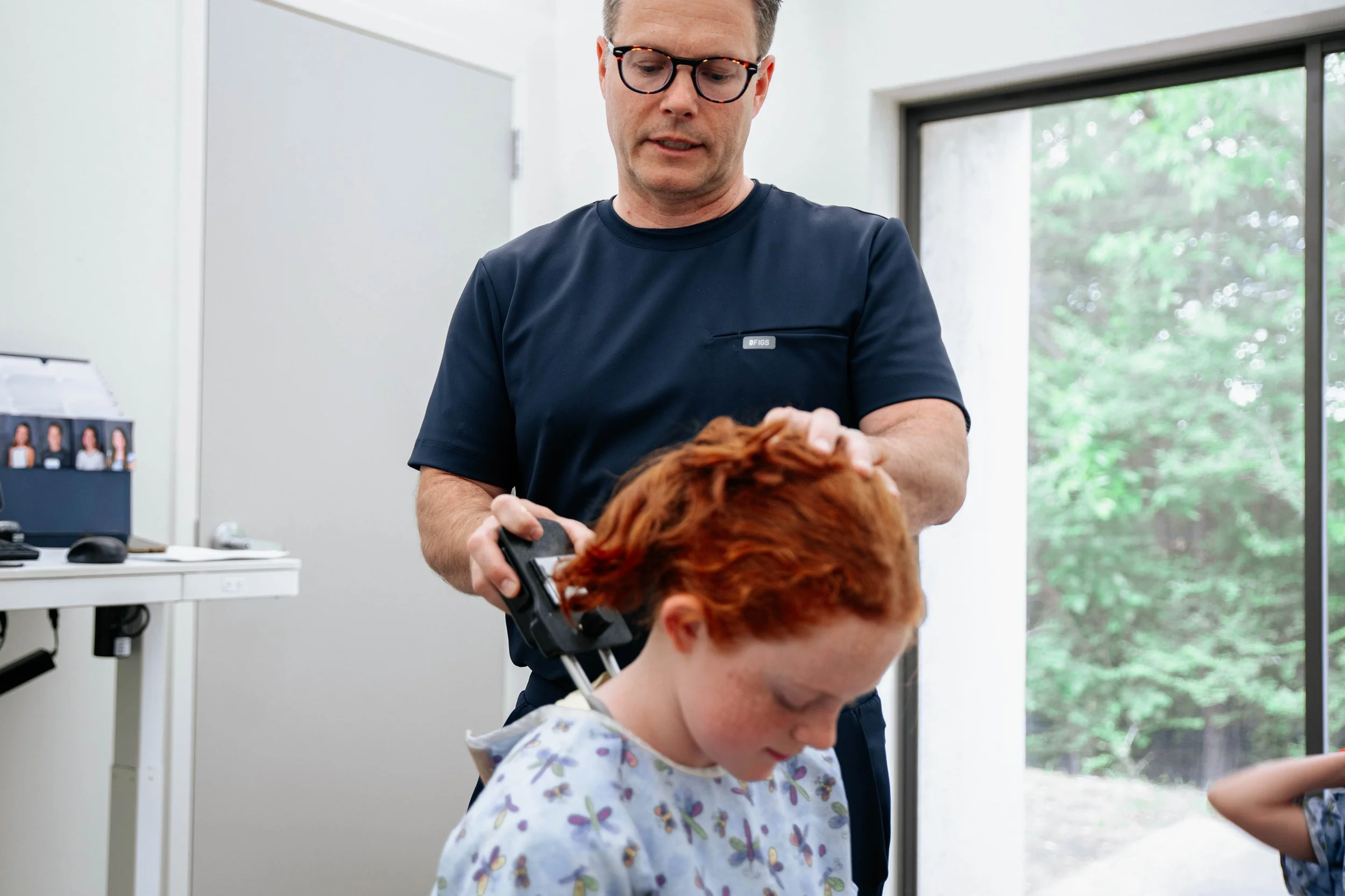 Dr. Prince performing chiropractic treatment for a child