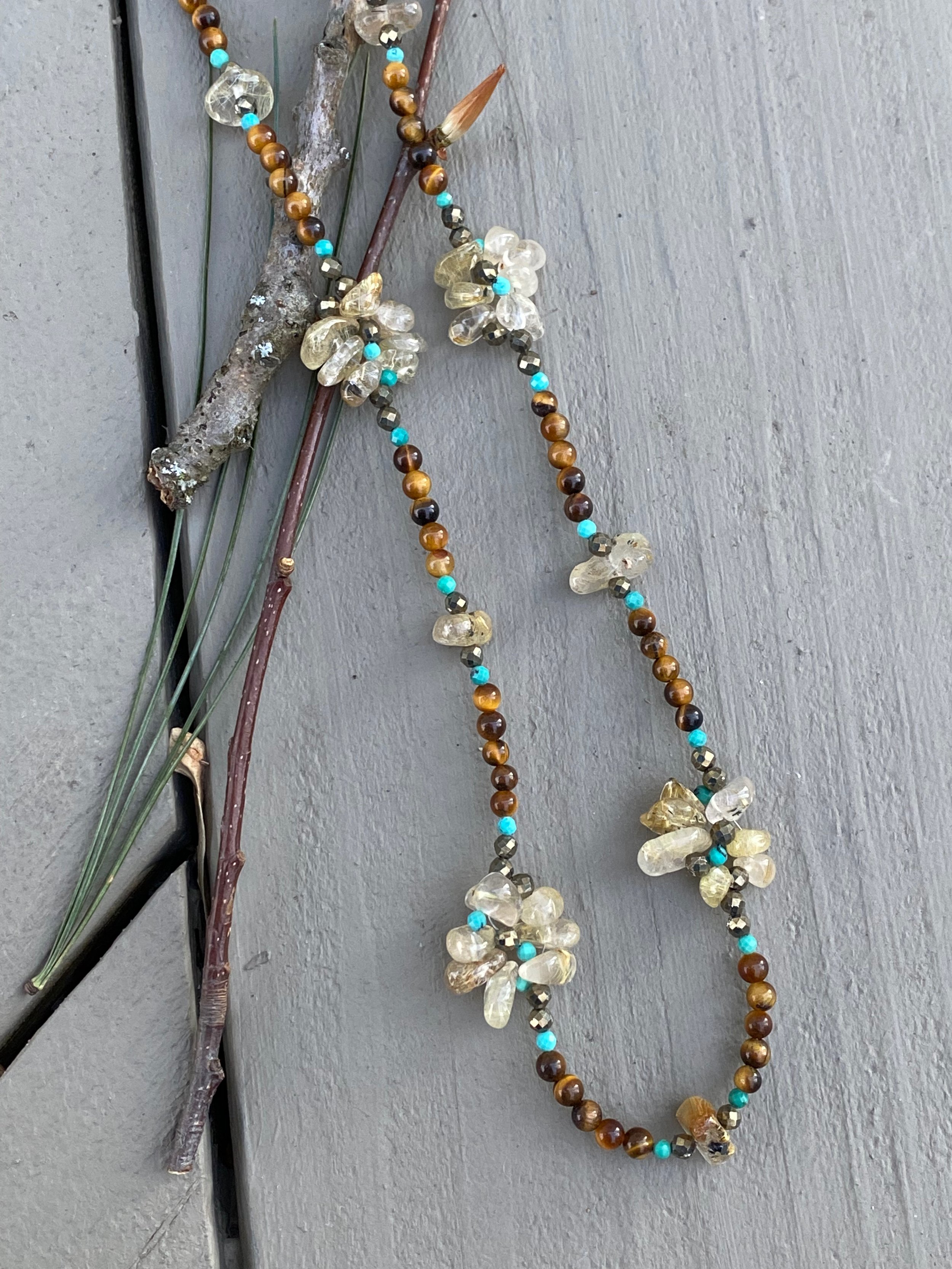 Apatachi handcrafted jewelry bohemian necklace. Rutilated Quartz Wildflowers with Tiger’s Eye, Hubei Turquoise and Pyrite long necklace