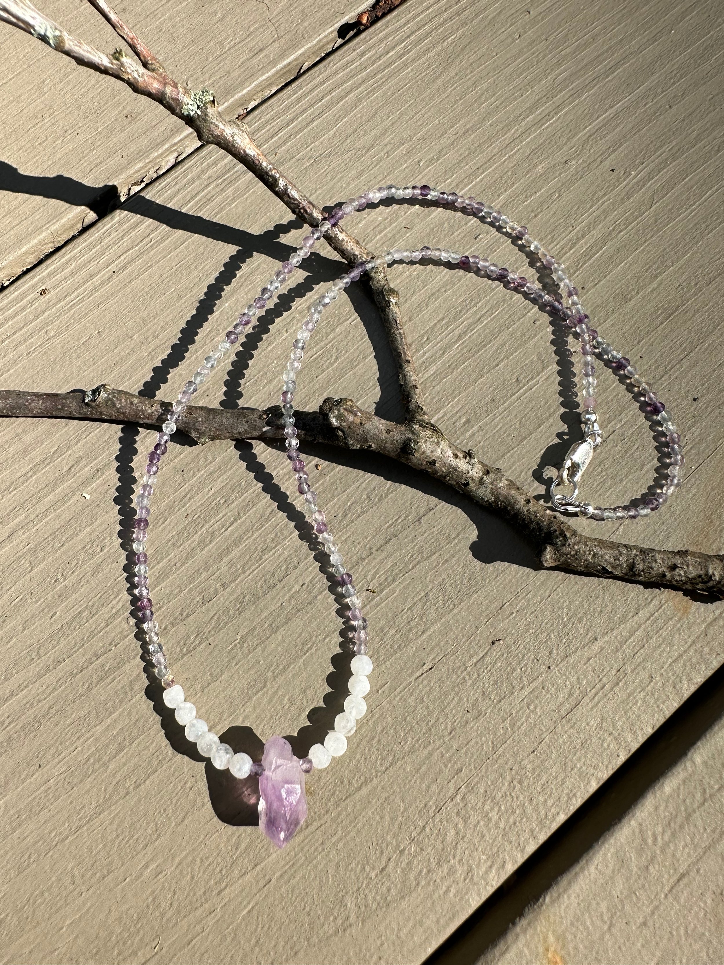 Apatachi handcrafted jewelry sophisticated bohemian necklace. Raw faceted amethyst stone with smooth moonstone and sparkling faceted Rainbow Fluorite gemstones
