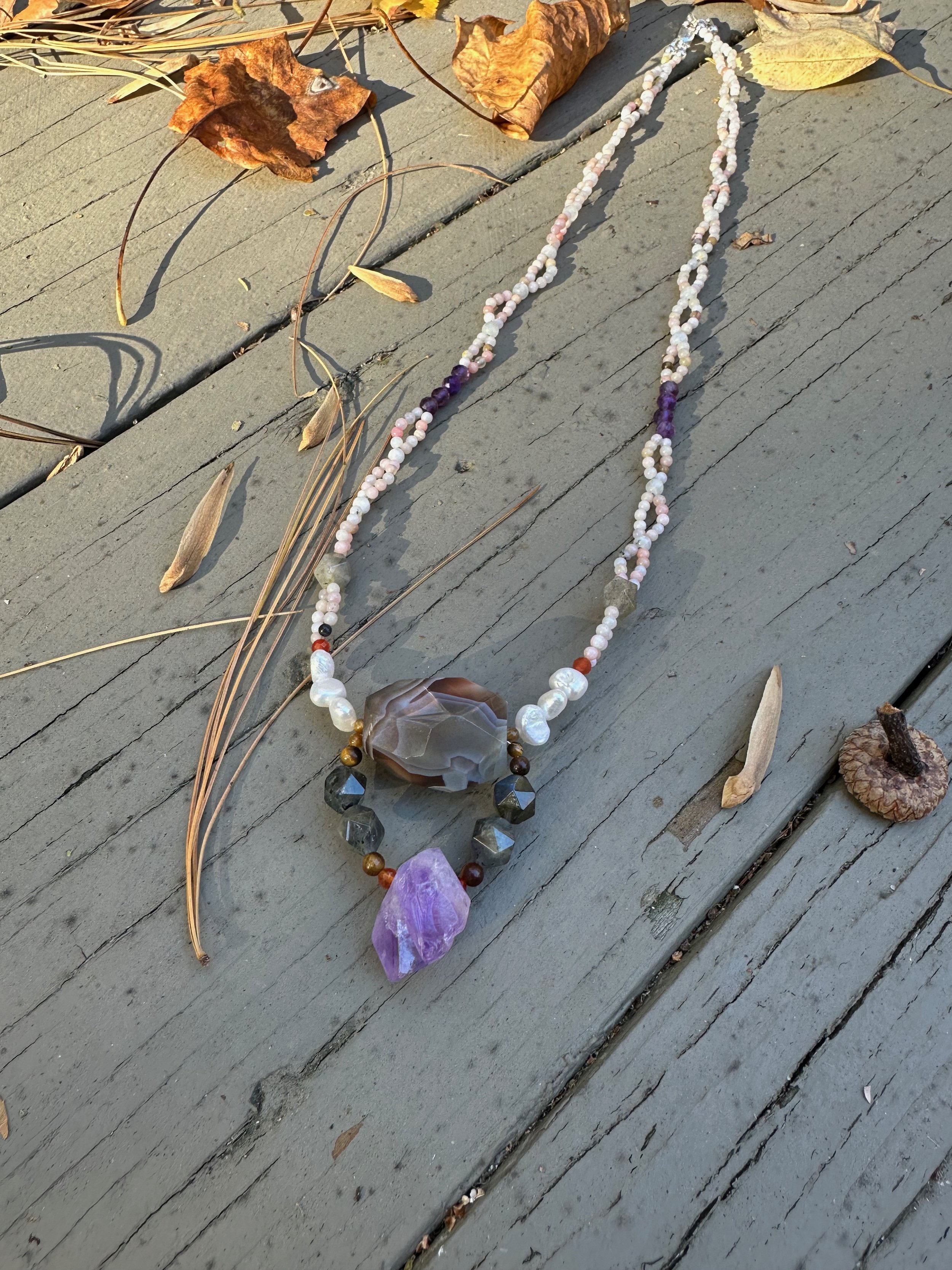 Apatachi handmade necklace. Bold centerpiece with faceted amethyst and agate on a woven pink opal necklace