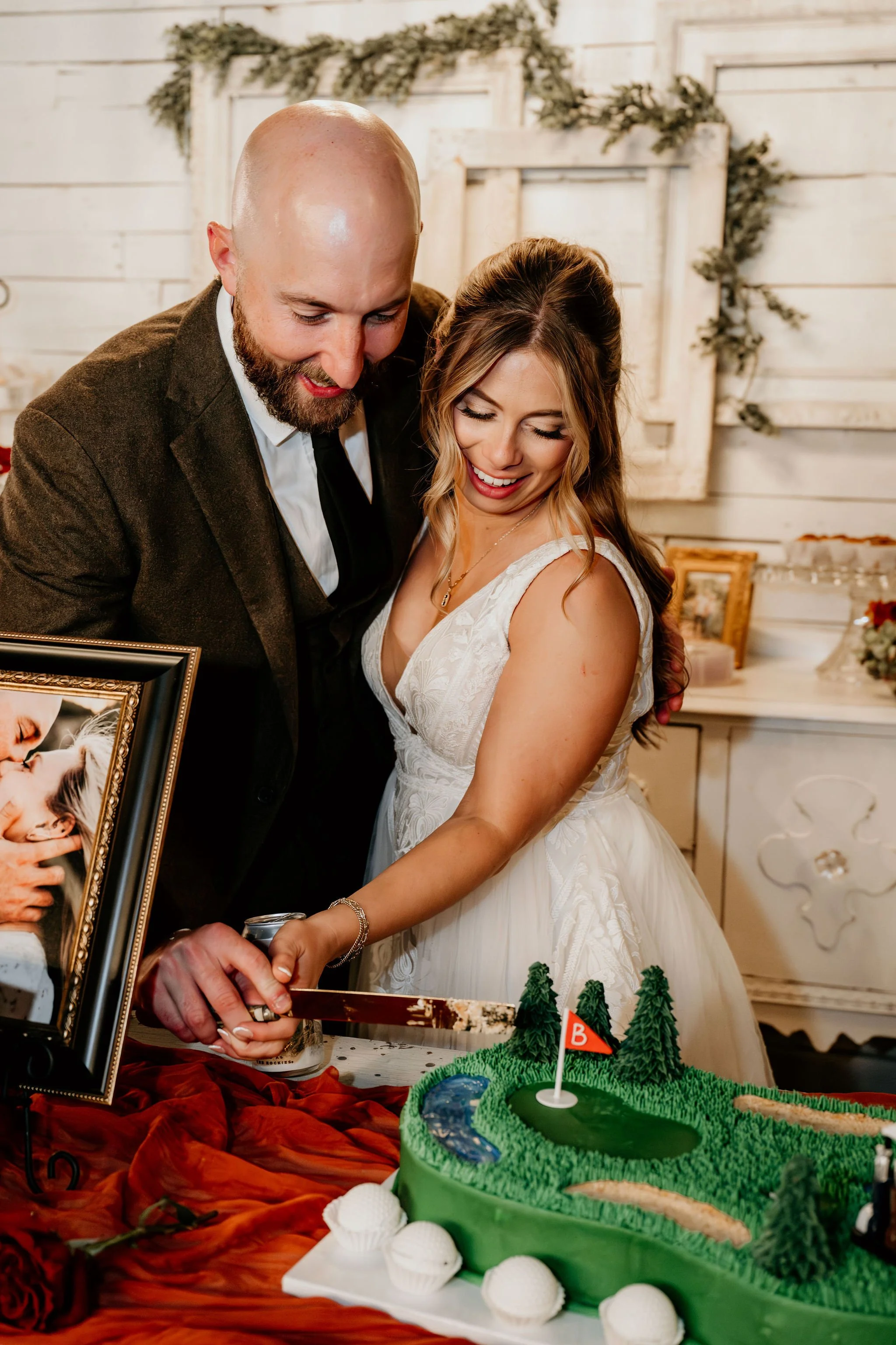 A bride and groom cutting a wedding cake together at their wedding reception.