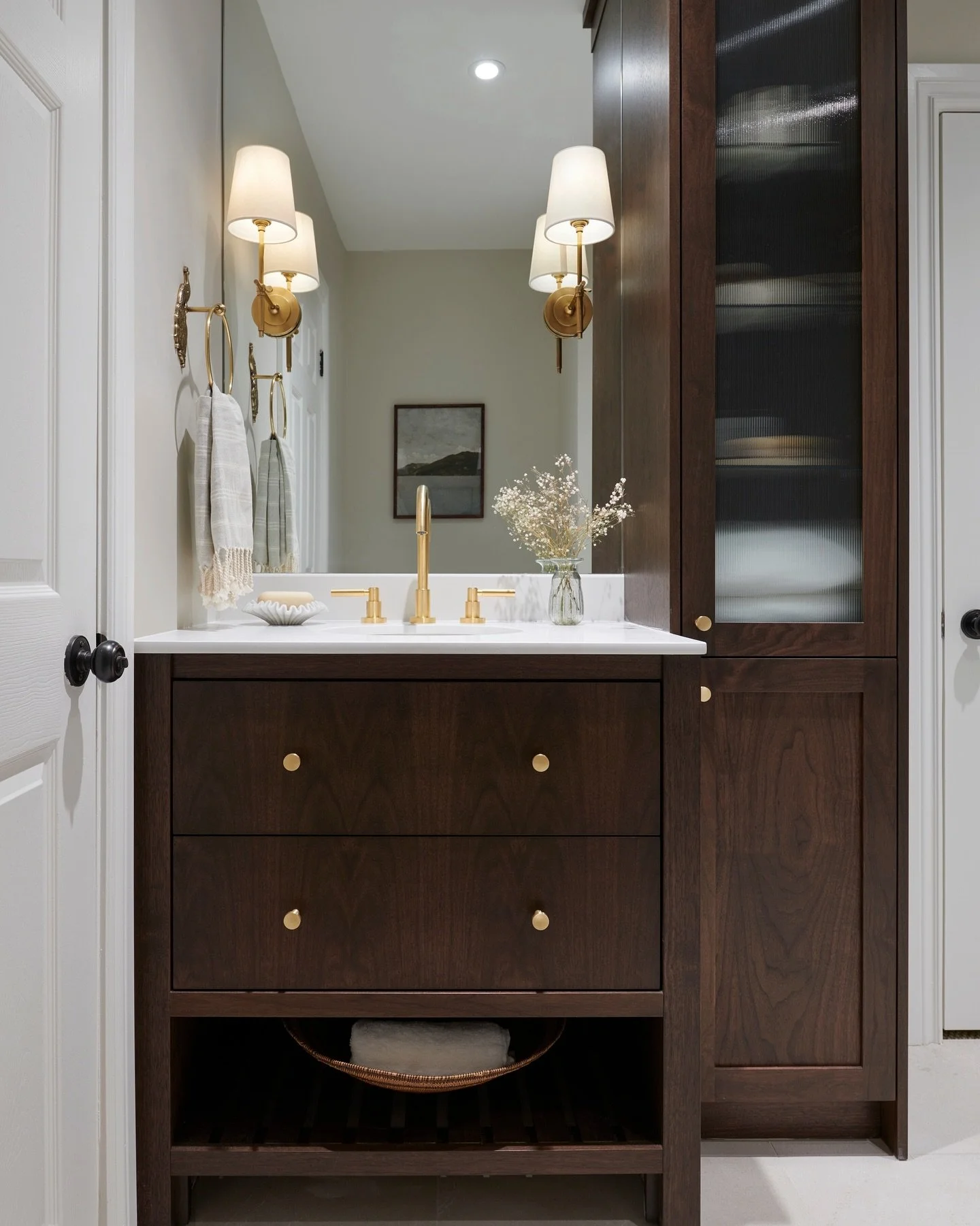 Want the feel of a luxurious hotel spa suite at home? Look no further than this Cinderella-worthy guest bath renovation. Deep wooden tones paired with elegant brass fixtures make this custom vanity feel like its own oasis.⁠
⁠
Design: @thehouseoftori⁠