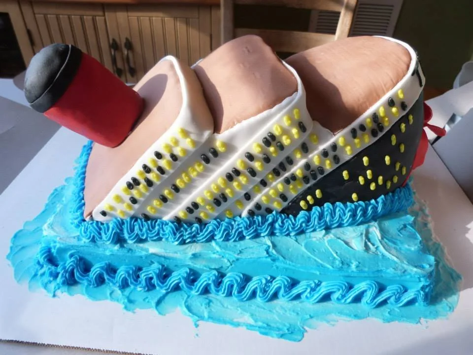 Sculpted Titanic ship cake designed for themed event