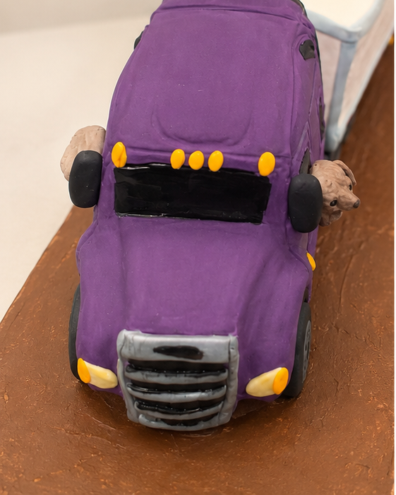 A head-on look at this custom sculpted semi truck cake reveals the hand-shaped details that make novelty cakes so much fun. Designed to capture the personality of a real truck, every element was handcrafted from edible materials.