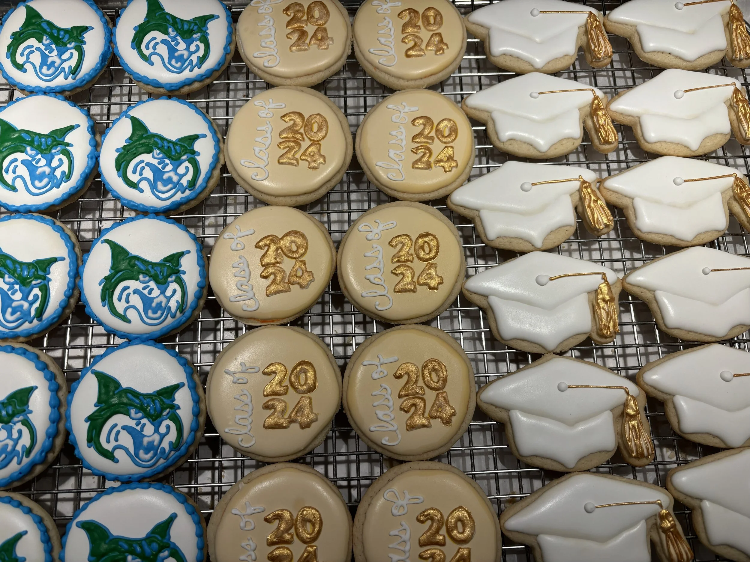 Cookies decorated for graduation and the class of 2024, with designs including a bobcat, the year 2024, and a graduation cap with a tassel.