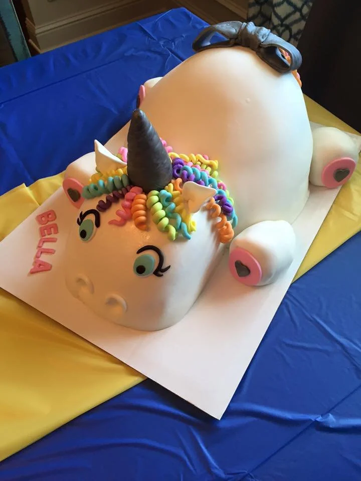Colorful unicorn cake with rainbow mane and sculpted horn
