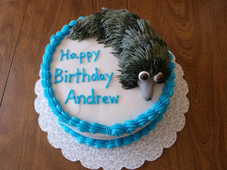 Detailed sculpted weasel cake with textured fur and lifelike shaping