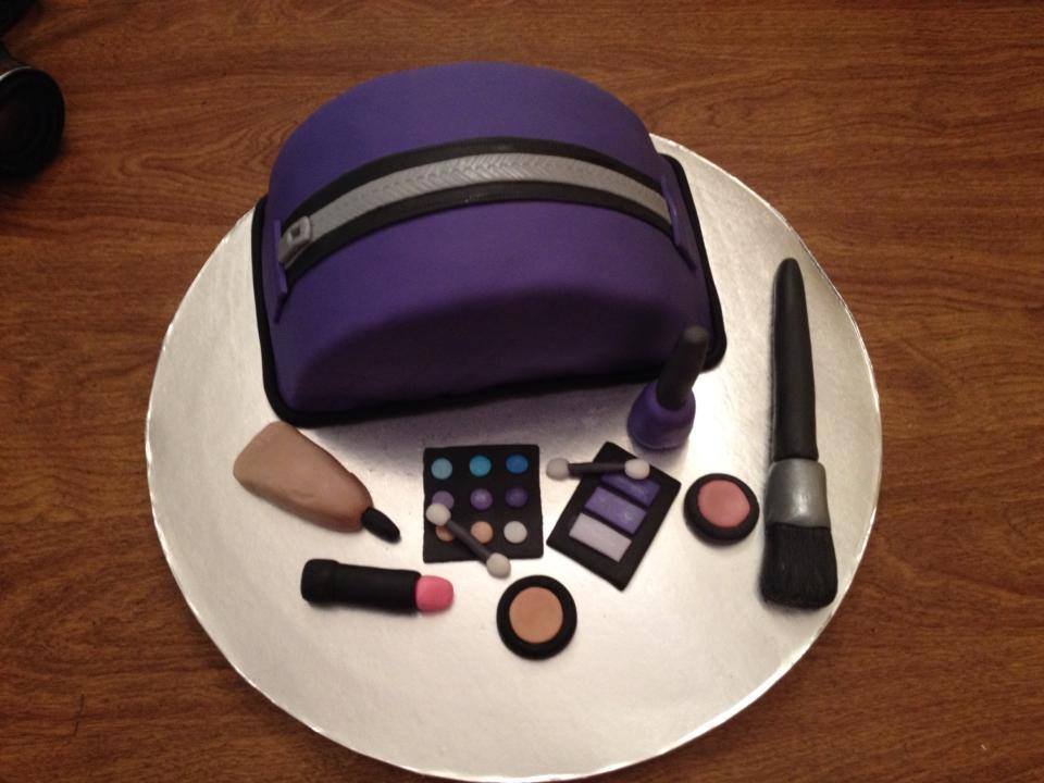 Sculpted makeup bag cake with edible cosmetics and brush