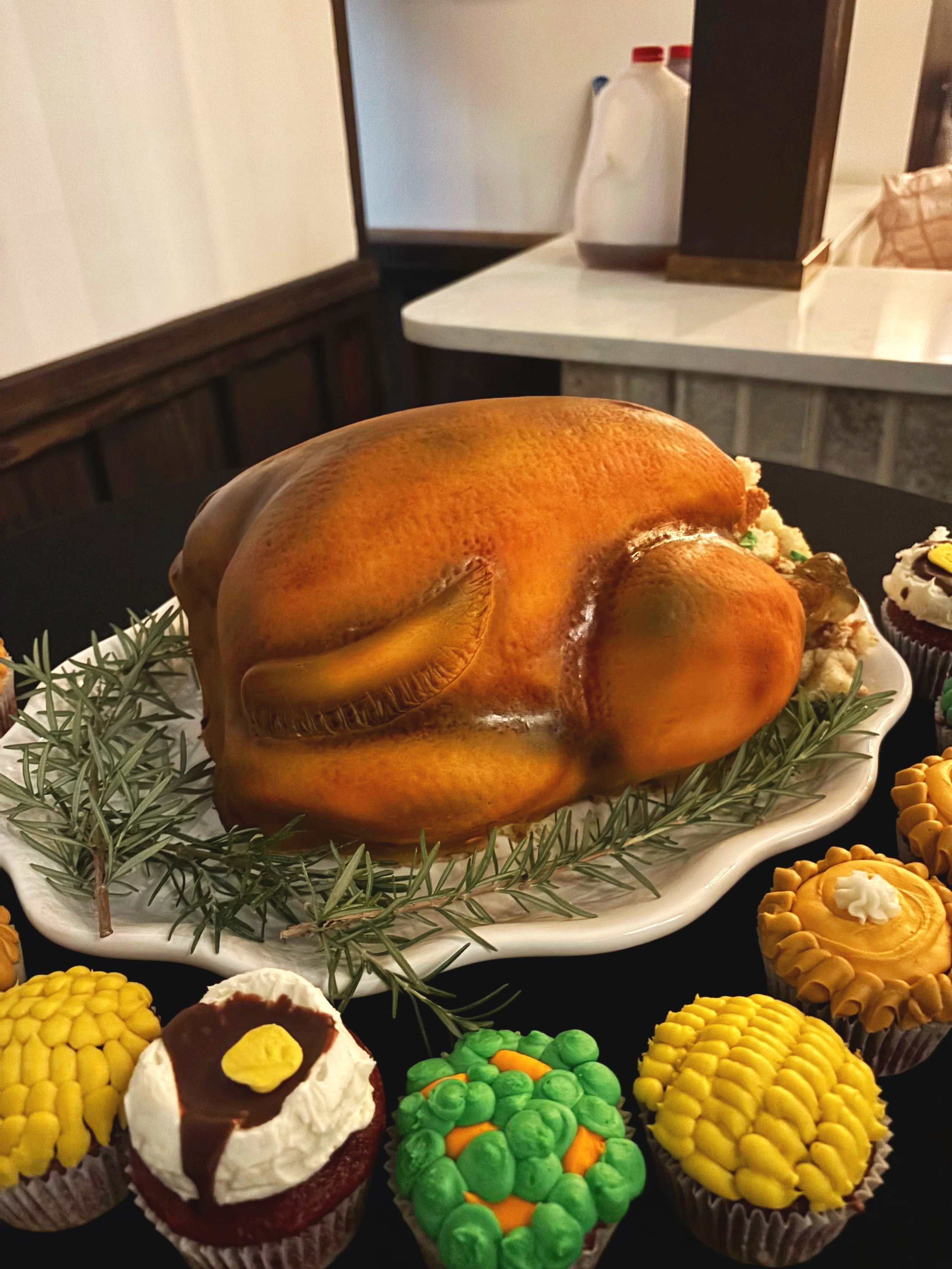 Realistic roasted turkey cake with cupcake side dishes created by Artful Cakery by Julie in Flowery Branch, Georgia.