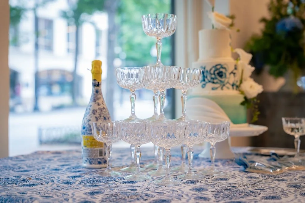 Celebration meets sophistication 🥂 The blue patterned linens, crystal glassware, and delicate cake details created the dreamiest southern wedding reception aesthetic.

Planning, Design and Styling, Officiant- @forgetmeknotevents23 Planning, Design, 