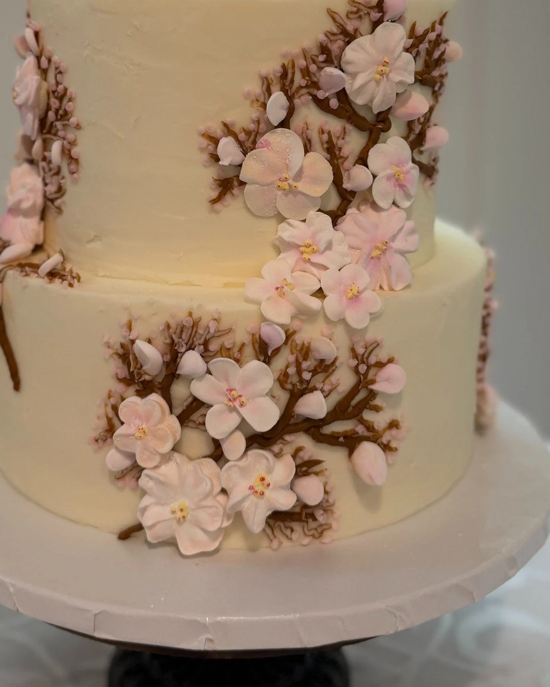 A different perspective, same soft beauty 🌸

This design was inspired by the movement and nature surrounding the venue, wrapping each tier with delicate blossoms.

Perfect for spring weddings in North Georgia.

Would you prefer a spring or fall wedd