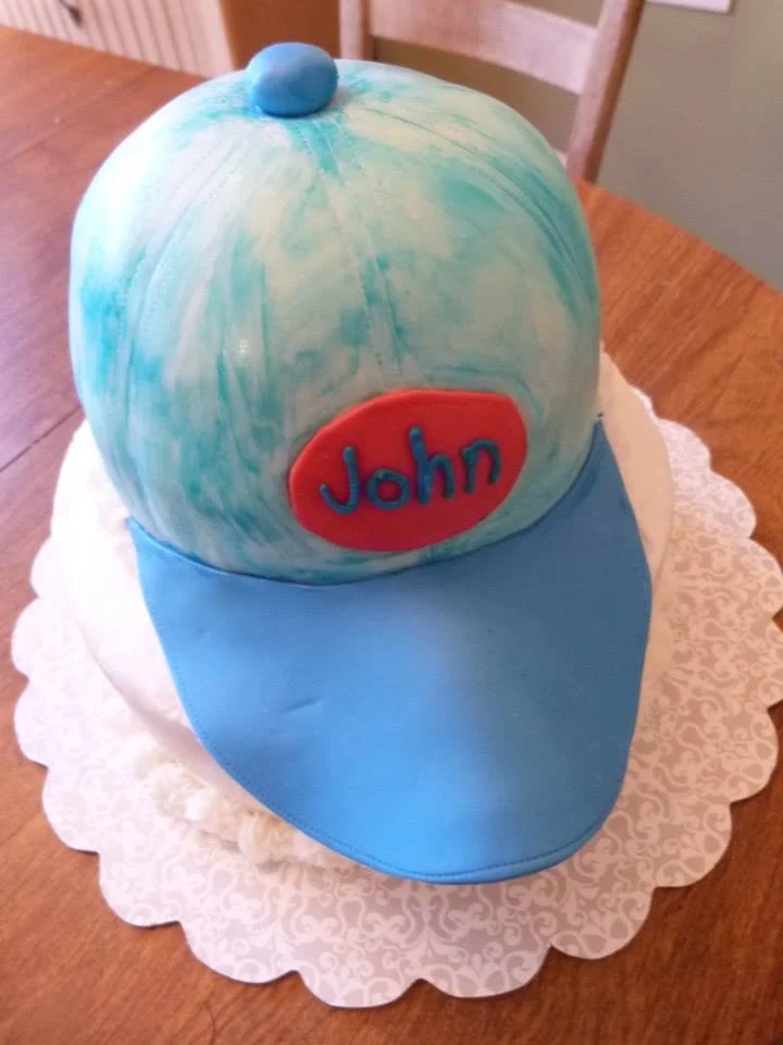Sculpted baseball cap cake with realistic stitching detail designed by Atlanta cake artist Artful Cakery by Julie