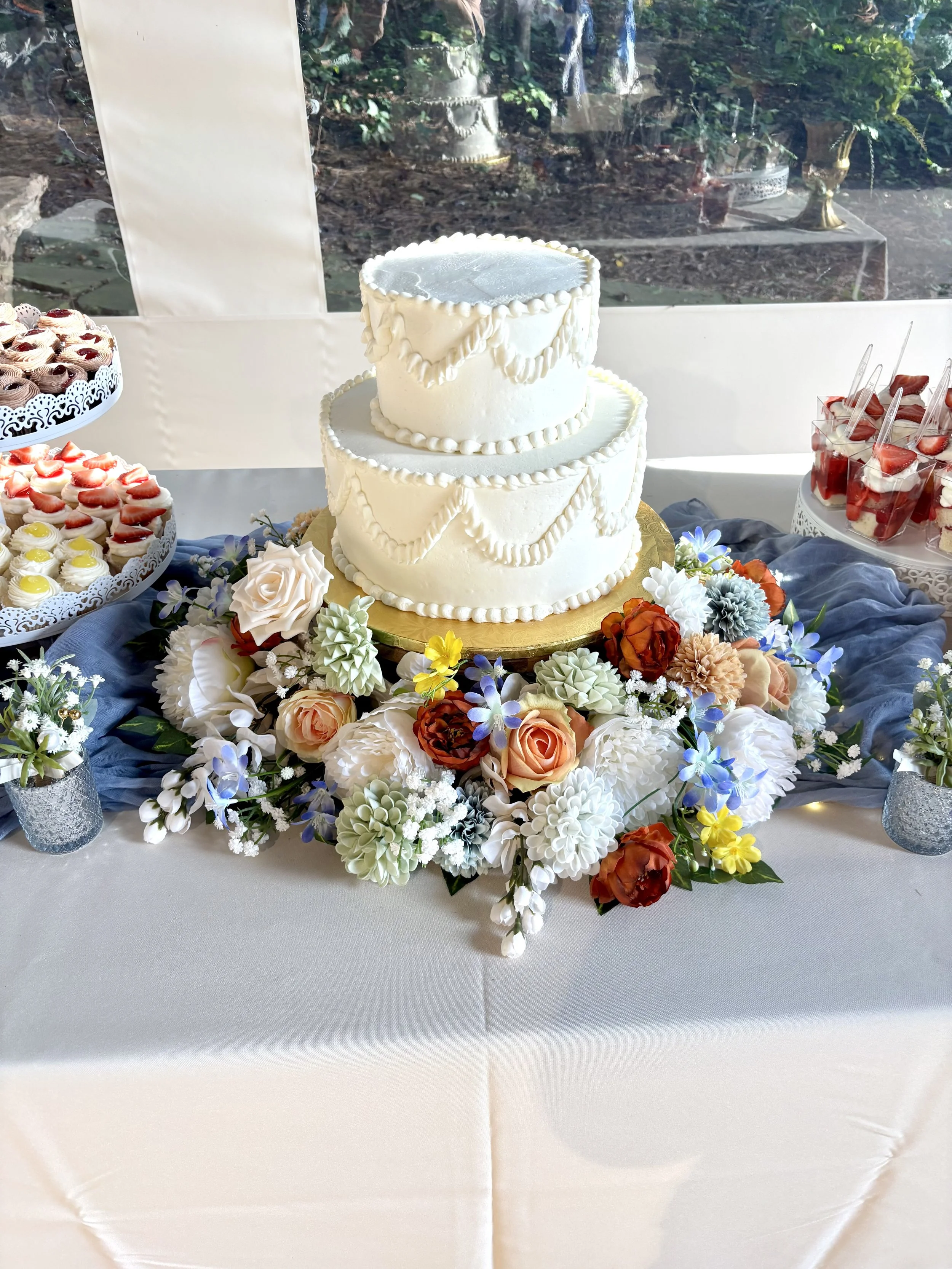 Vintage buttercream piped wedding cake with a flower meadow at a wedding at Brasstown Valley Resort and Spa in Young Harris, Georgia