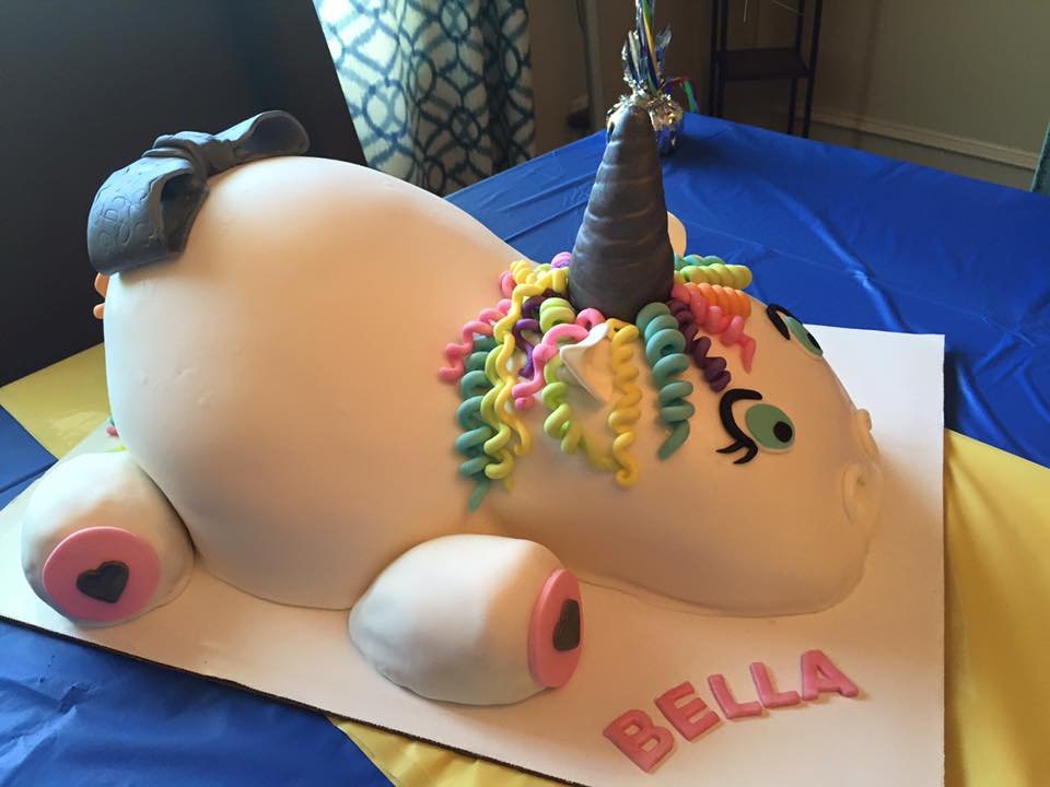 Colorful unicorn cake with rainbow mane and sculpted horn