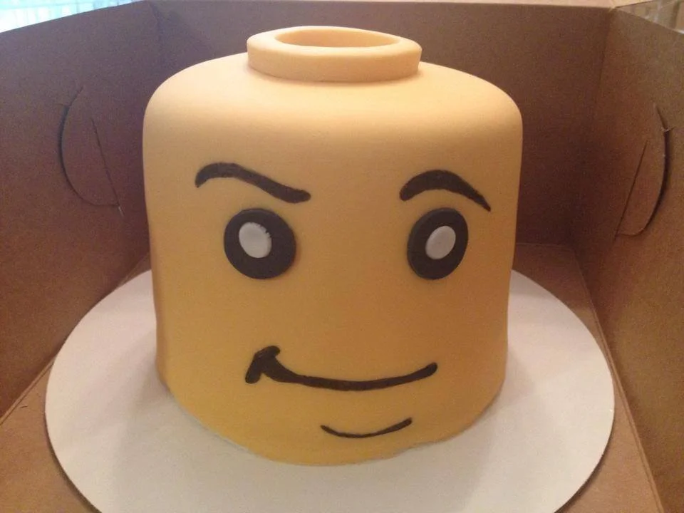 Sculpted building block character head cake with smooth fondant finish