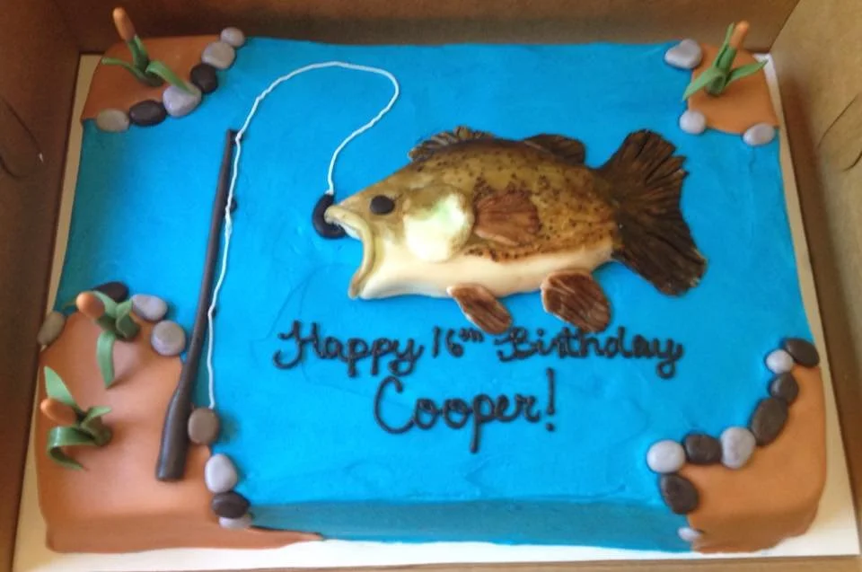 Fishing themed cake with edible pond, rod, and bass jumping from water