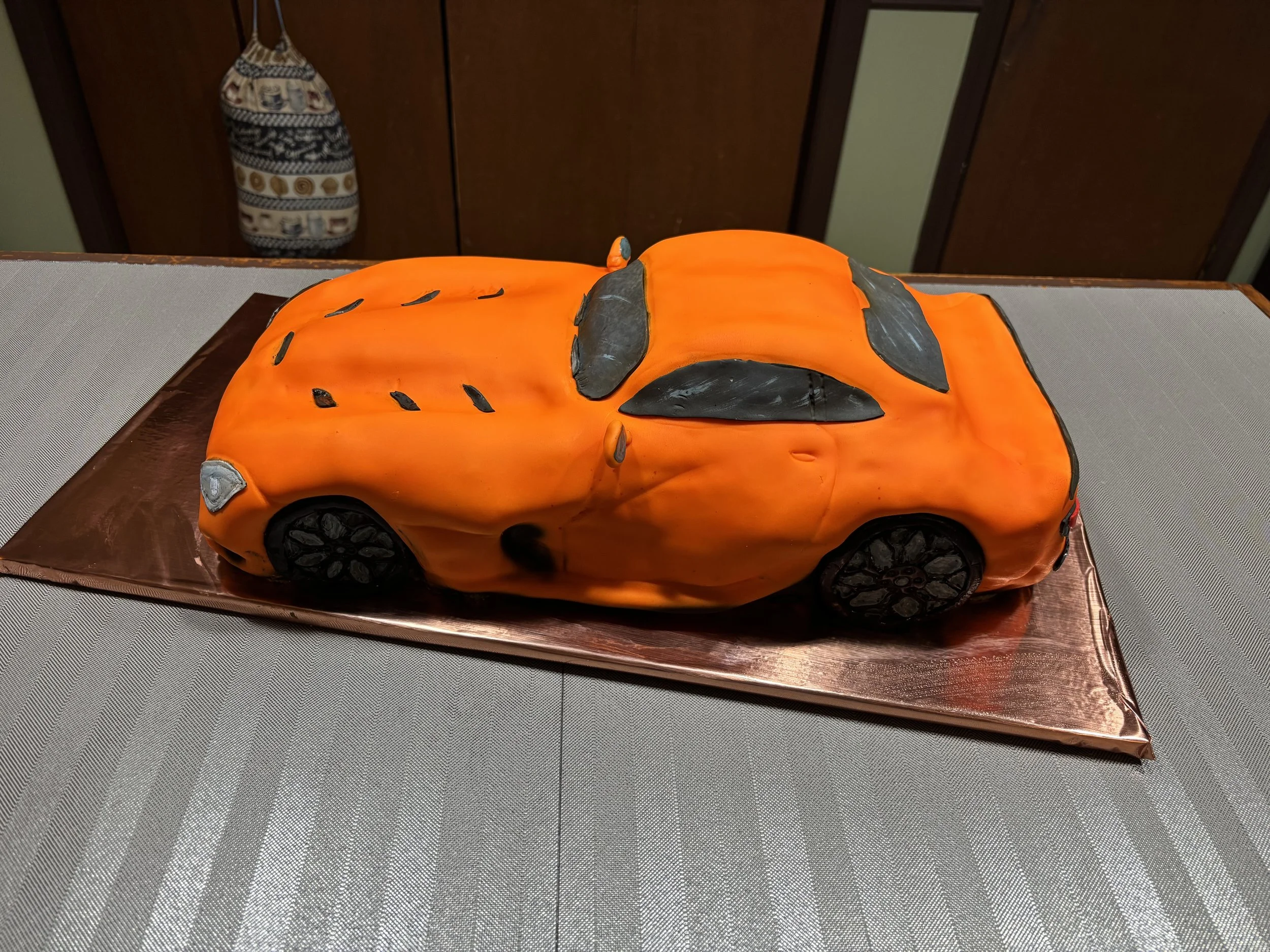 Orange Dodge Viper sports car cake sculpted with realistic automotive details.