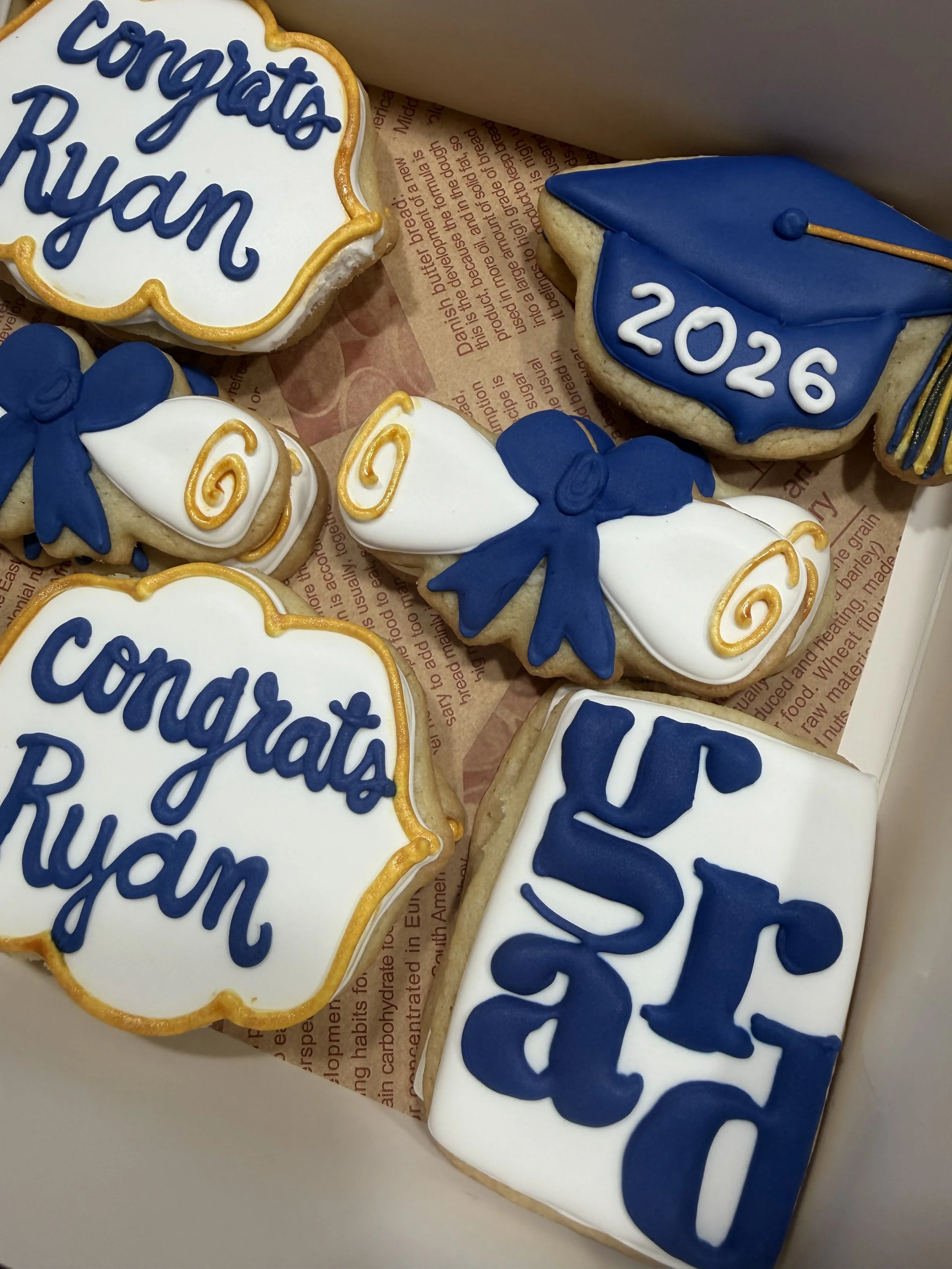 White, navy, and gold graduation cookies
