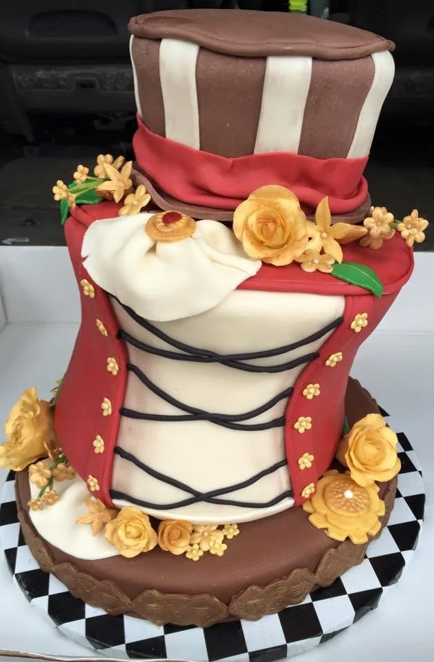 Intricate steampunk corset cake with metallic accents and themed hat