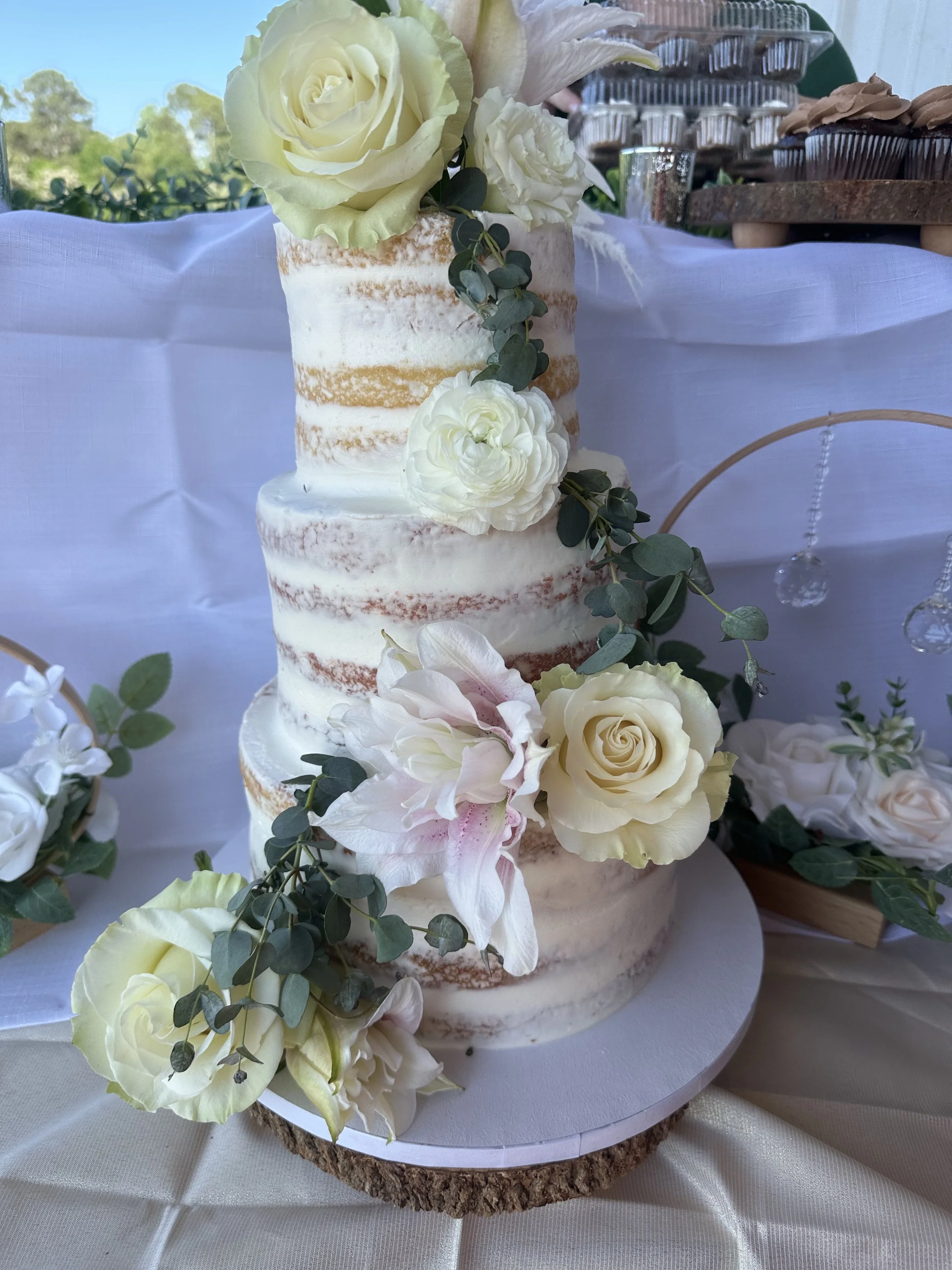 Naked iced three tiered buttercream wedding cake at a horse barn in Madison, Georgia