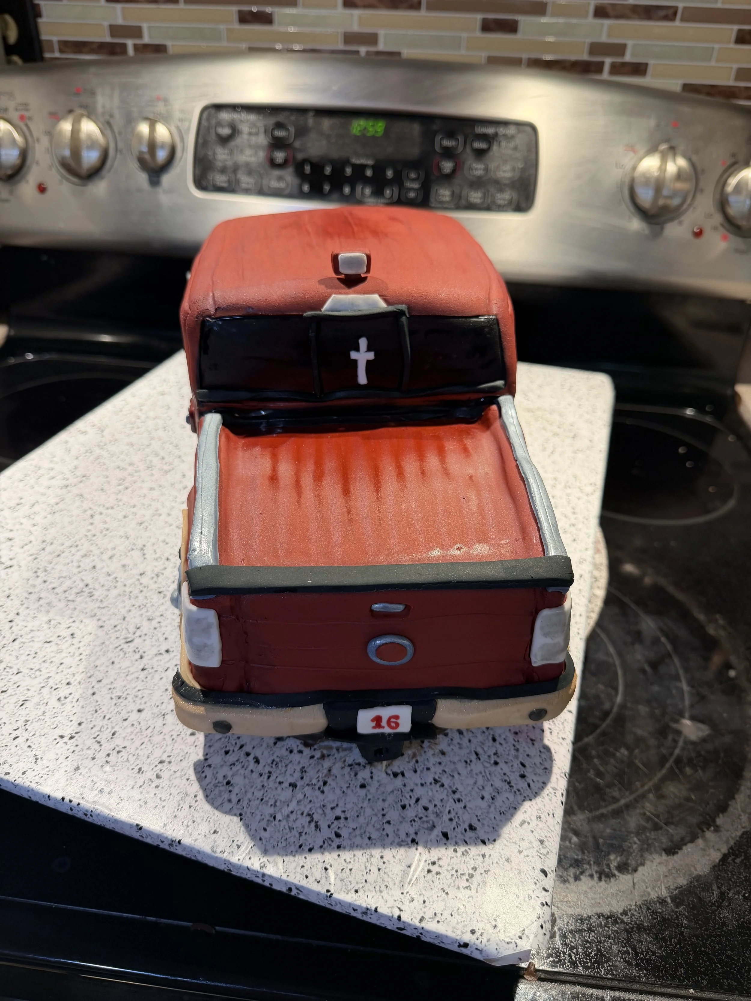 The back of the truck is just as detailed as the front, featuring a realistic truck bed, tailgate, and personalized license plate for the birthday celebration.